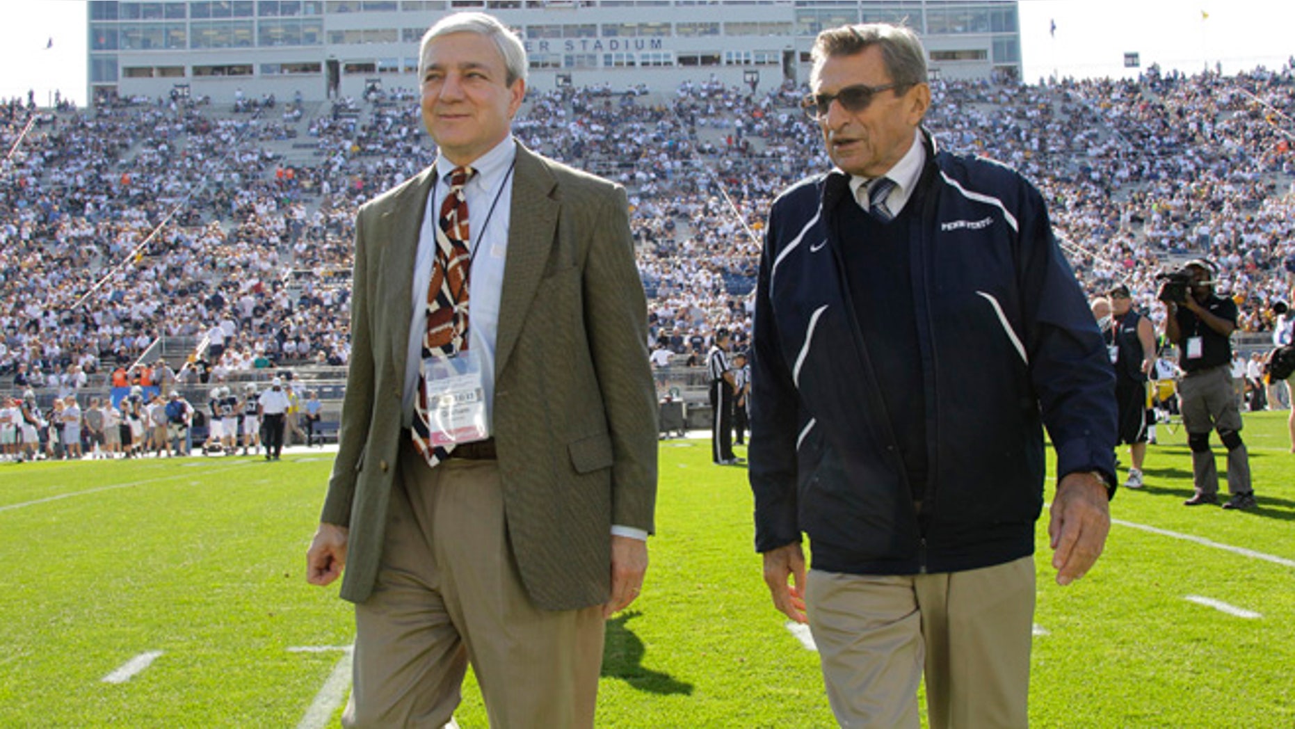 Oct. 8, 2011: This file photo shows Penn State president Graham Spanier, left, and head football coach Joe Paterno before a college football game against Iowa in State College, Pa.