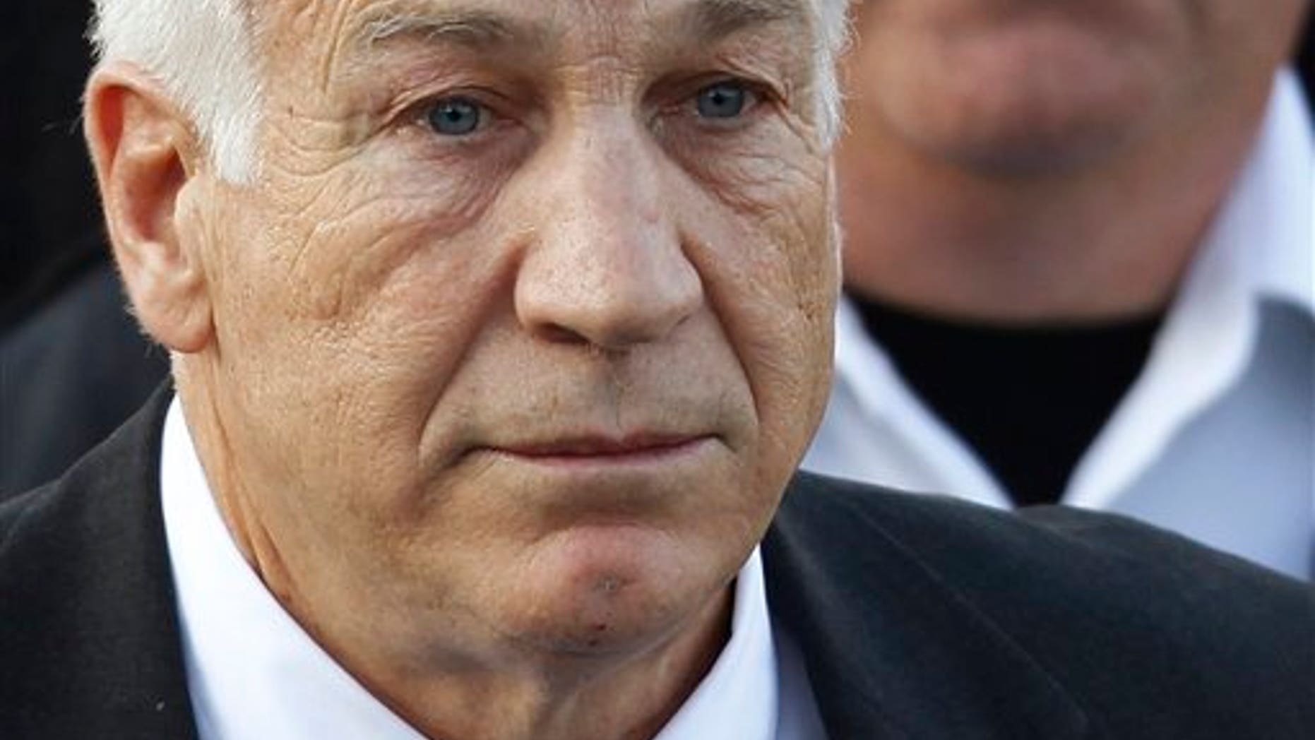 In this Dec. 13, 2011 file photo,Jerry Sandusky, the former Penn State assistant football coach charged with sexually abusing boys, leaves the Centre County Courthouse in Bellefonte, Pa.