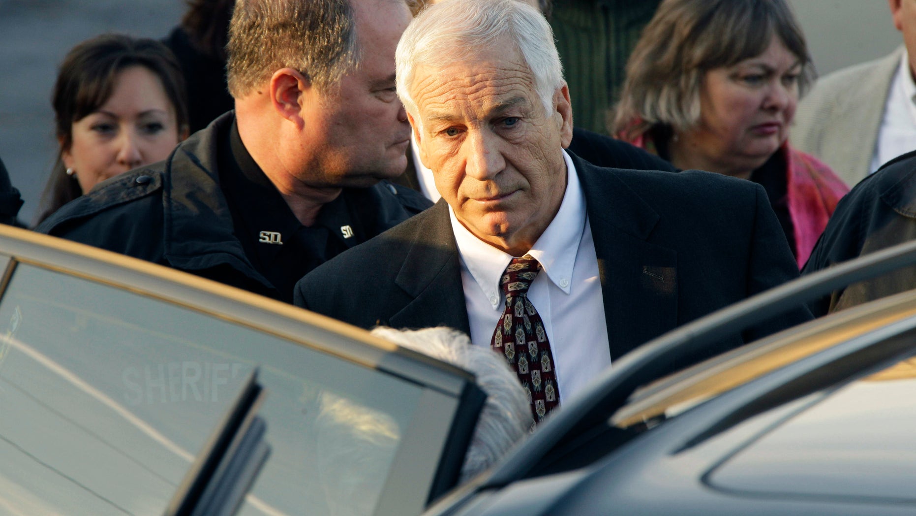 December 13: Former Penn State University assistant football coach Jerry Sandusky walks to his attorney’s car as he leaves the Centre County Courthouse after waiving a preliminary hearing in Bellefonte, Pa.