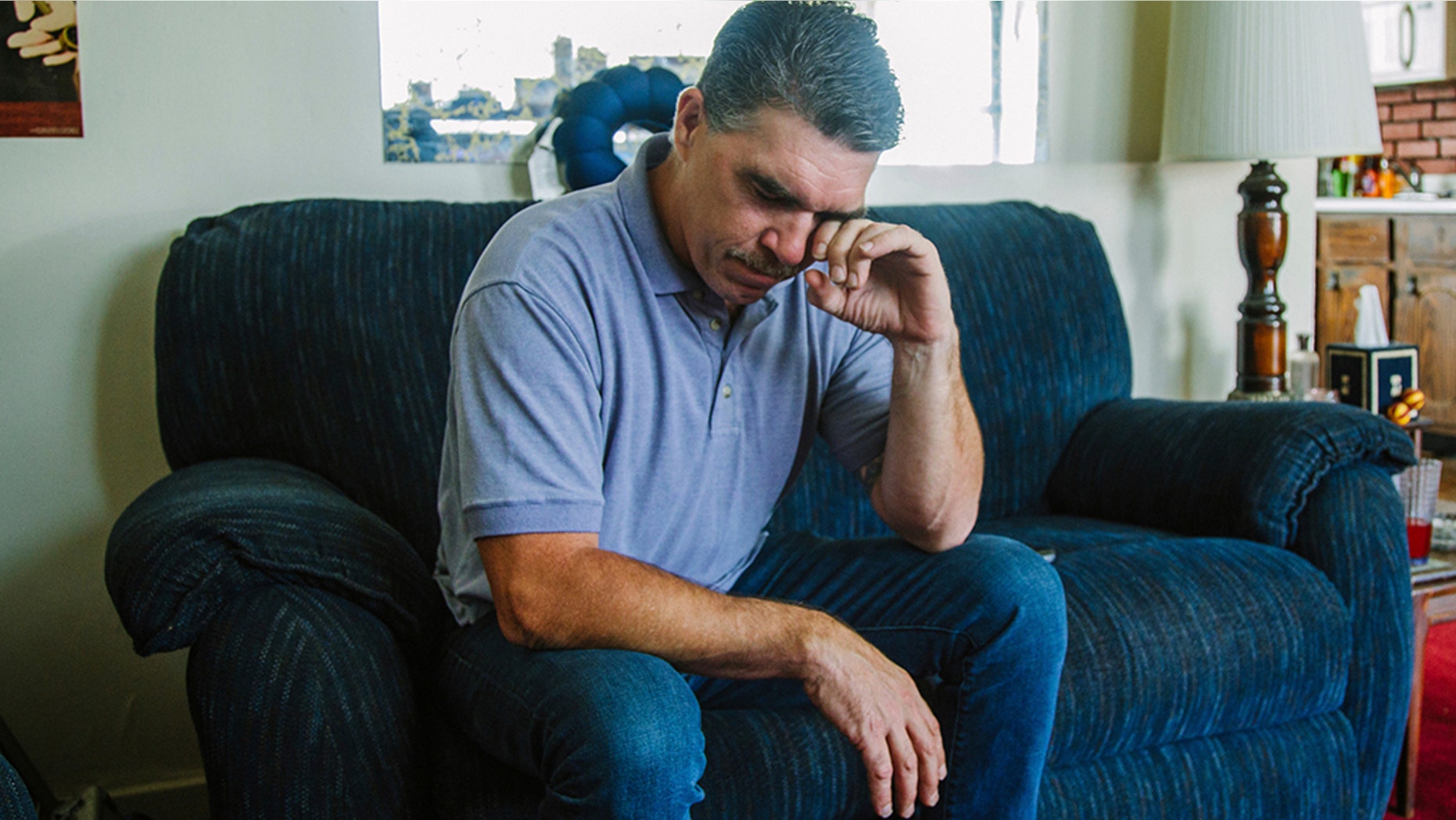 Robert Mizic, 47, watching a news conference on the grand jury report investigating sexual abuse within the Catholic Church in Pennsylvania at his home on Tuesday. Mizic says he was abused by his parish priest at a Catholic Church in suburban Philadelphia 35 years ago.