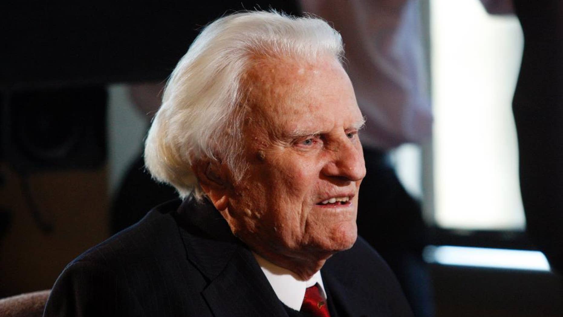 FILE - In this Dec. 20, 2010, file photo, Rev. Billy Graham is interviewed at the Billy Graham Evangelistic Association headquarters in Charlotte, N.C. Graham plans to celebrate his 96th birthday, on Friday, Nov. 7, 2014, with family and friends. Last year, 900 people attended a two-hour party for Graham at an Asheville hotel. His son, the Rev. Franklin Graham, said Wednesday that his father is in good spirits, he's eating well, and his mind is still sharp. (AP Photo/Nell Redmond, File)