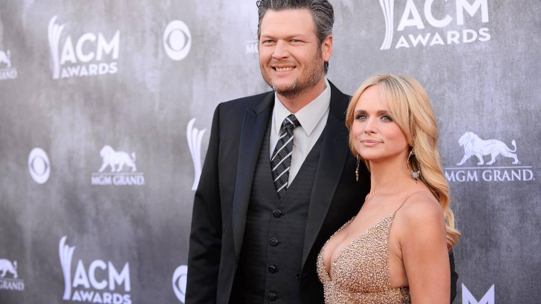 FILE - In this April 6, 2014 file photo, Blake Shelton, left, and Miranda Lambert arrive at the 49th annual Academy of Country Music Awards at the MGM Grand Garden Arena in Las Vegas. Lambert's really going to need a break after an already hectic week that now includes plane troubles, and Shelton is prepared to provide her with one. Lambert was already neck deep in the busiest week of the year when things took a turn toward the scary Tuesday, June 3, 2014, as the private jet ferrying Lambert and her team from New York to Nashville was forced to make an emergency landing in Clarksburg, West Virginia. (Photo by Al Powers/Powers Imagery/Invision/AP, file)