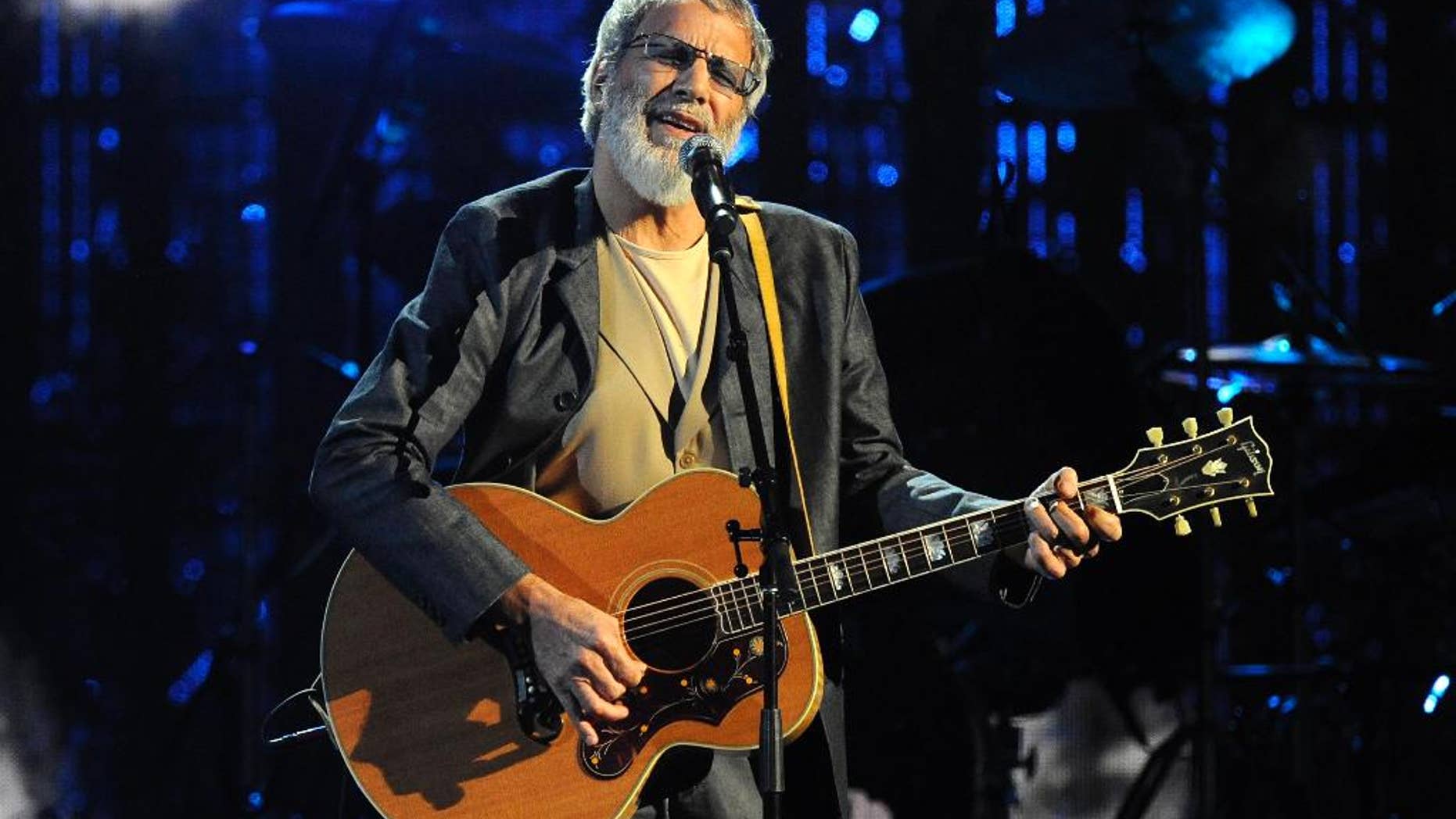FILE - In this April 10, 2014 file photo, Hall of Fame Inductee Cat Stevens performs at the 2014 Rock and Roll Hall of Fame Induction Ceremony in New York. Stevens is canceling his New York performance just weeks after announcing a six-city tour. Stevens said on his Facebook page Wednesday, Sept. 24, 2014, that he would not keep the New York engagement because its requirement for paper tickets has led to exorbitant resale prices. (Photo by Charlse Sykes/Invision/AP, file)