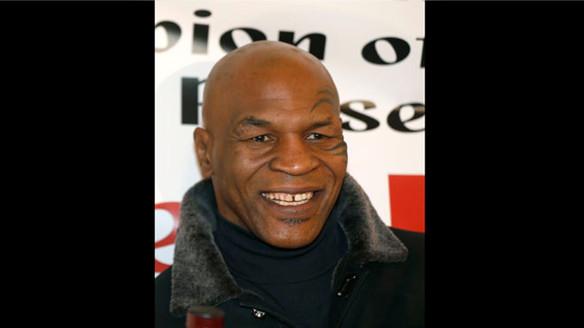 Feb. 16, 2013: File photo, former heavyweight champion Mike Tyson smiles during a promotional event for former five-time champion Evander Holyfield's Real Deal barbecue sauce at a Chicago grocery store.