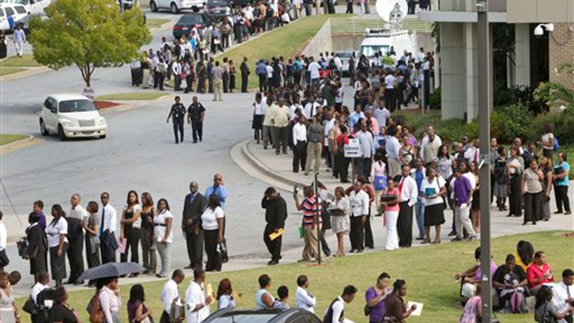 August 18: People wait in line during a job fair, sponsored by the Congressional Black Caucus on the campus of Atlanta Technical College in Atlanta, Georgia.