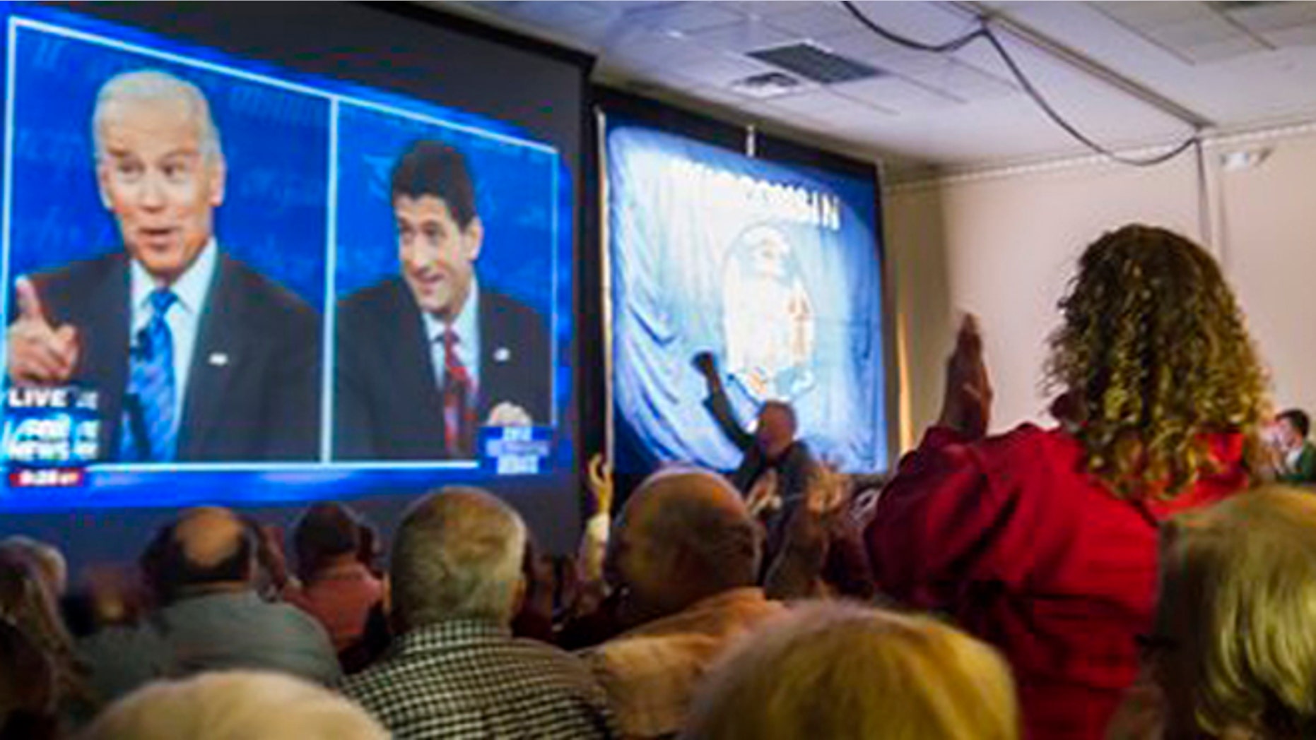 Supporters of Republican vice presidential nominee Rep. Paul Ryan, of Wisconsin, gather at the Holiday Inn Express in Janesville, Wis. to watch his debate with Vice President Joe Biden on Thursday, Oct. 11, 2012. (AP Photo/The Janesville Gazette, Mark Kauzlarich)