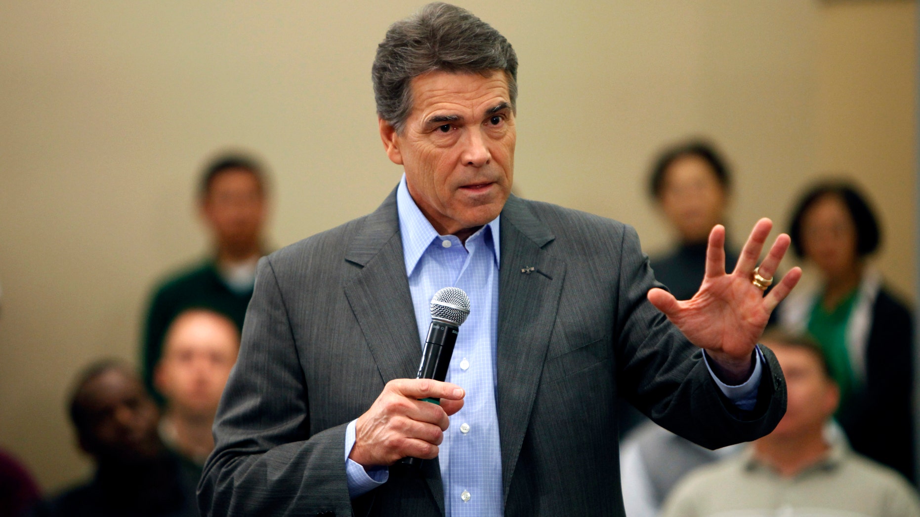 Republican presidential candidate Texas Gov. Rick Perry speaks during a town hall meeting with employees at Pioneer Hi-Bred, Thursday, Nov. 3, 2011, in Johnston, Iowa. (AP Photo/Charlie Neibergall)