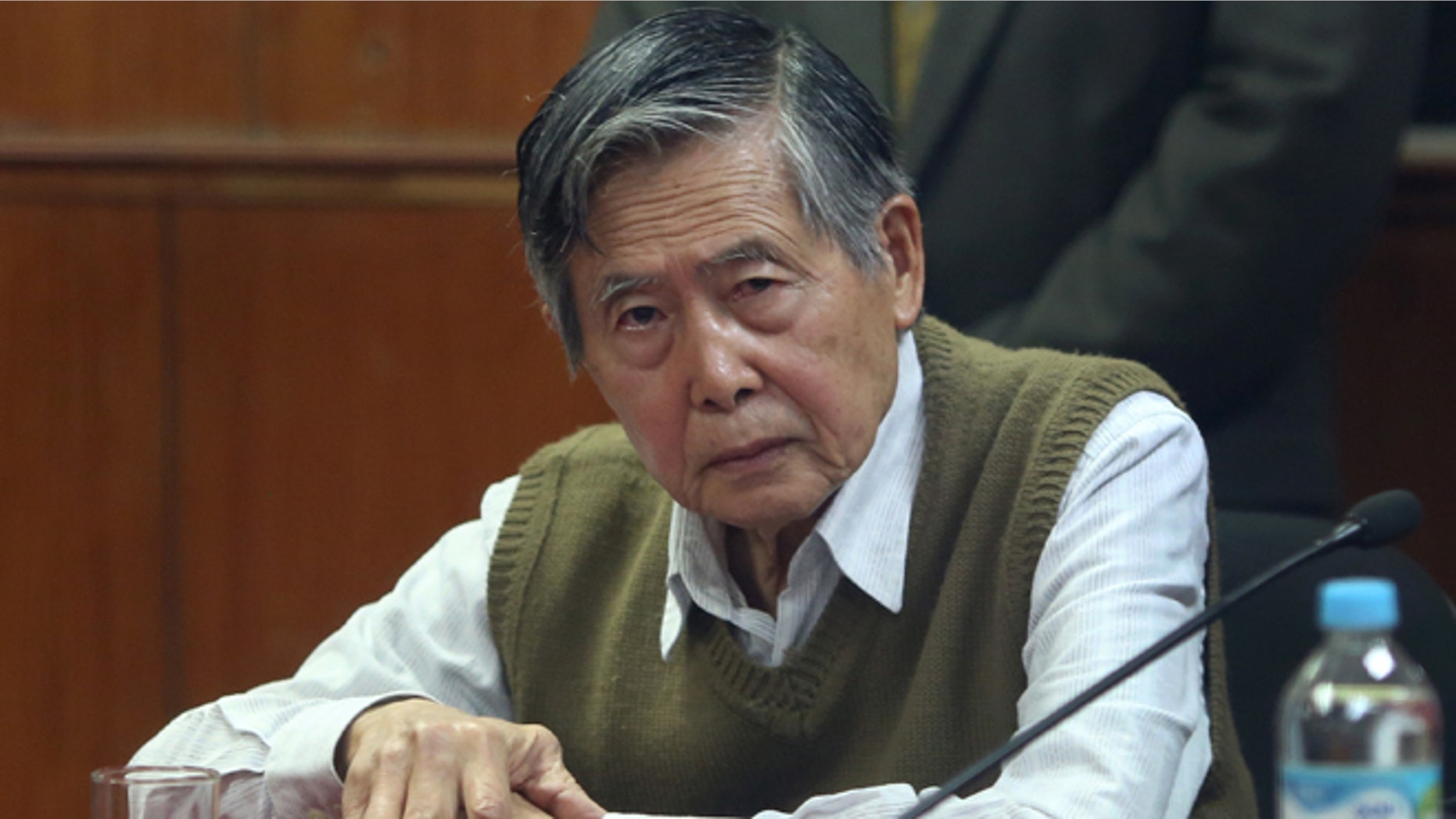 FILE - In this Oct. 29, 2013 file photo, jailed former President Alberto Fujimori attends a hearing at a police base on the outskirts of Lima, Peru. Many of the nations rural, indigenous poor have flocked to the support of his daughter Keiko, who is running for president, grateful for her fathers success in routing guerrillas who preyed on their communities. But tens of thousands have marched in the streets of the capital against the return of any Fujimori, haunted by the memory of the elders bloody crackdown on dissent and corrupt government, which have him serving 25 years in prison. Peru holds its presidential election on June 5, 2016. (AP Photo/Martin Mejia, File)