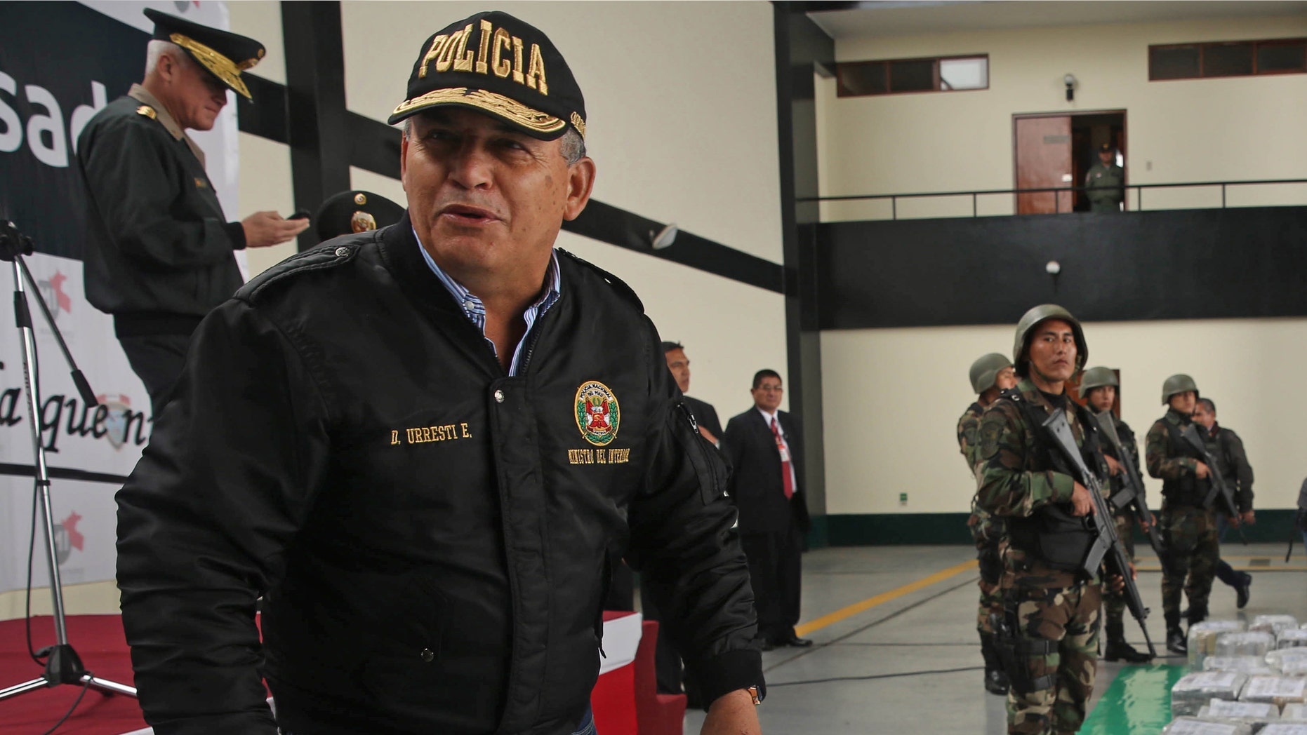 FILE - In this Sept. 1, 2014 file photo, Peru's Interior Minister Daniel Urresti talks with the press during the presentation of seized drugs at a police base in Lima, Peru. Urresti, a former army general, has been charged with murdering a journalist during the country's conflicts 26 years ago, prosecutor Luis Landa announced. Landa said in interviews published Sunday, March 1, 2105 by three newspapers that he is seeking a 25-year prison term for Urresti based on evidence that, as local army intelligence chief at the time, he was responsible for the murder of Hugo Bustios. (AP Photo/Martin Mejia, File)