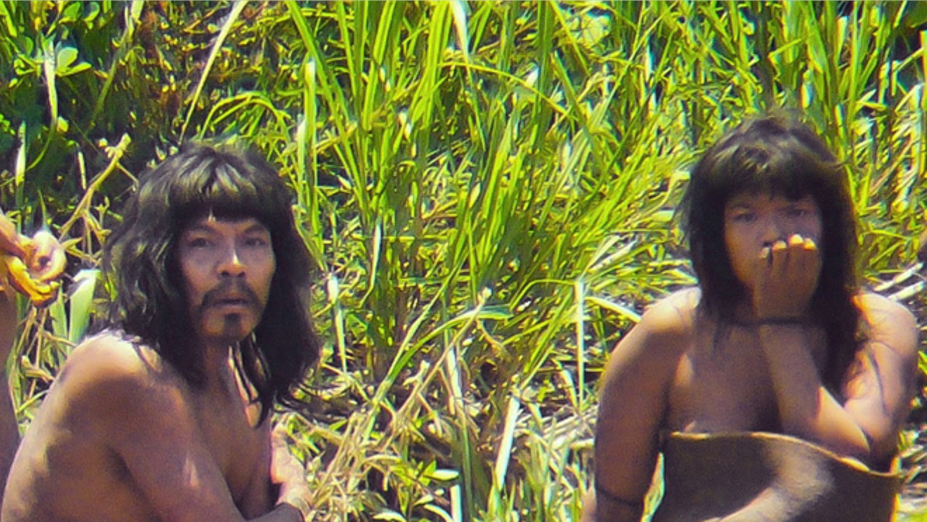 FILE - This Nov. 2011 file photo, shows members of the Mashco-Piro tribe, photographed at an undisclosed location near the Manu National Park in southeastern Peru. More than 100 Mashco-Piro appeared across a river from the remote community of Monte Salvado in Madre de Dios state, says Klaus Quicque the president of the regional FENAMAD indigenous federation on Monday, Aug. 19, 2013. The Maschco-Piro first appeared in May 2011 after more than two decades in voluntary isolation. (AP Photo/Diego Cortijo, Survival International, File)