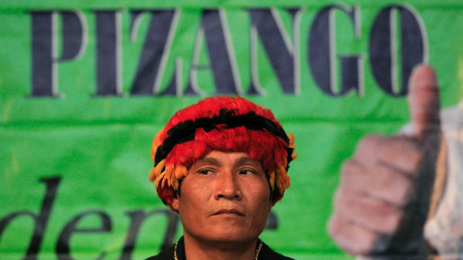 FILE - In this Nov. 18, 2010, file photo, Peru's Amazon leader Alberto Pizango looks on during an act after announcing his candidacy for Peru's 2011 presidential elections in Lima, Peru. Pizango and 52 others went on trial Wednesday in the killing of a dozen police officers after security forces fired on protesters opposed to plans to open the Amazon to widespread logging and oil drilling. (AP Photo/Martin Mejia, File)