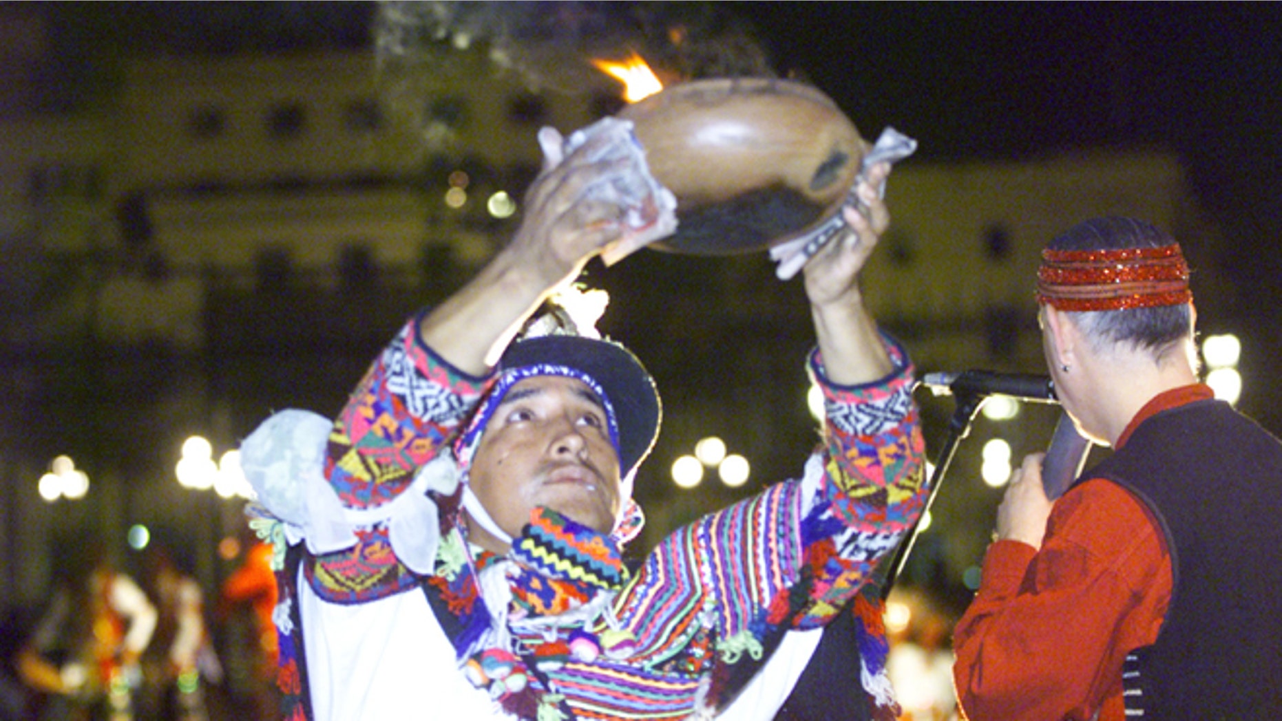 A Peruvian Shaman performs a ritual offering which pays homage to the land November 23, 2001 at the entrance of the presidential palace in Lima, Peru. (Photo by Getty Images)