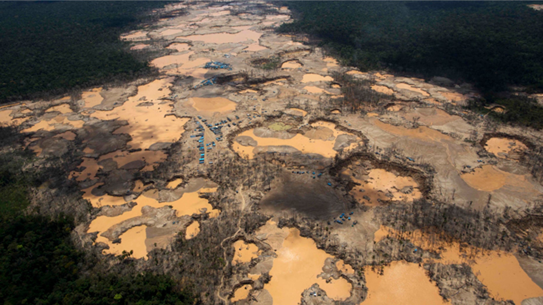 Craters filled with water, caused by illegal gold mining activities, in La Pampa, in Peru's Madre de Dios region.