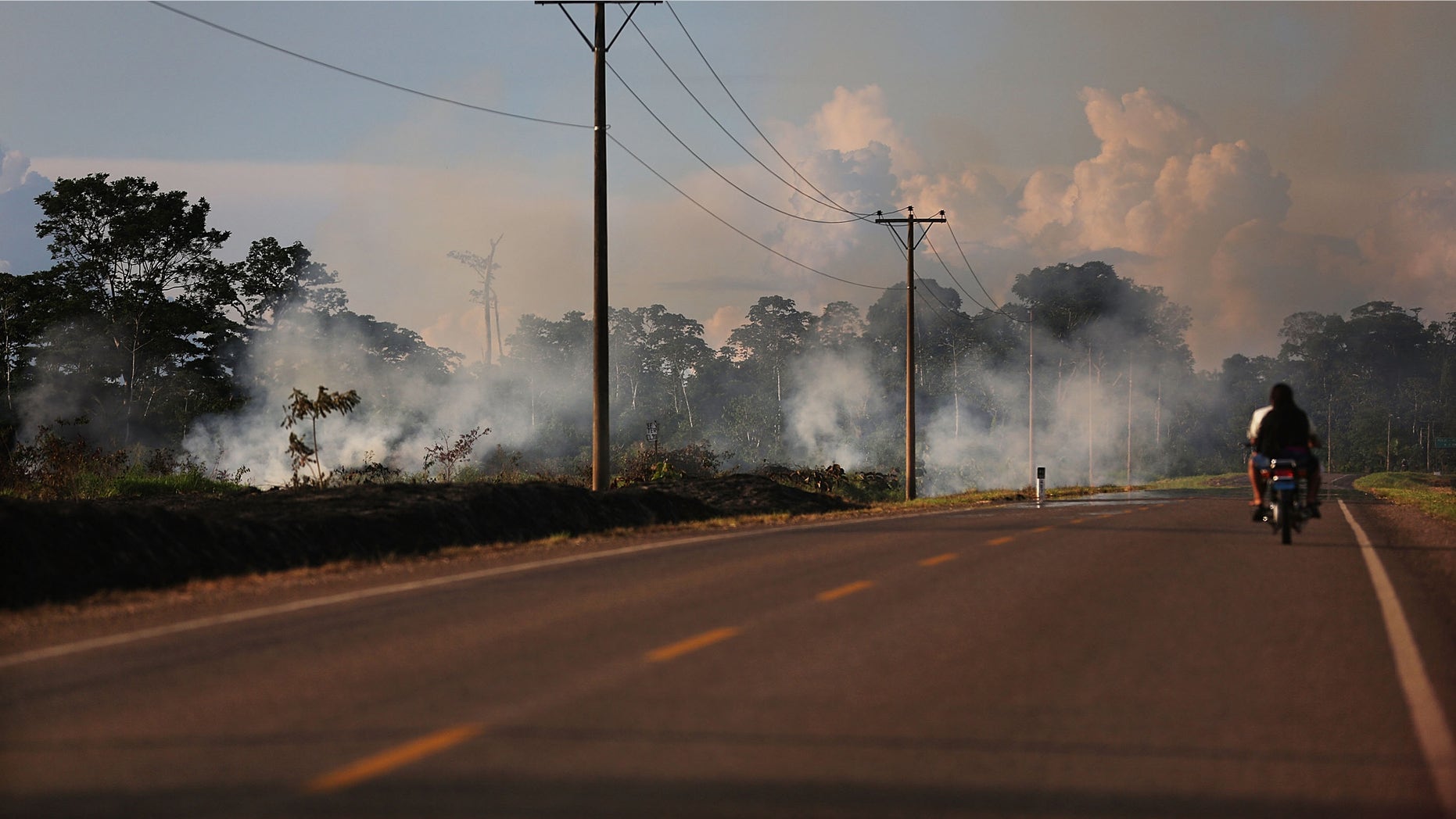 MADRE DE DIOS REGION, PERU - NOVEMBER 16: Fire burns in a deforested section along the Interoceanic Highway in the Amazon lowlands on November 16, 2013 in Madre de Dios region, Peru. The biologically diverse Madre de Dios ('Mother of God') region has seen deforestation from gold mining in the area triple since 2008, when gold prices spiked during global economic turmoil. In addition, deforestation along the recently constructed highway has occurred due to logging and farming as the highway has opened access to previously remote areas. (Photo by Mario Tama/Getty Images)