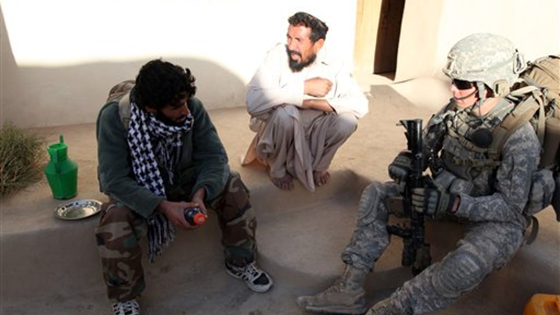 Sept. 24, 2010: In this image released by the U.S. Army, Army 2nd Lt. Stephen Petraeus from Alpha Company, 3rd Platoon, 1st Battalion, 503rd Infantry, 173rd Airborne Brigade Combat Team, speaks to an Afghan local national as his house is searched in the Chak District of Wardak province, Afghanistan. Challenged by a congressman to be honest about how long American troops might have to fight in Afghanistan, Army Gen. David Petraeus revealed that he has a special ally in his belief that U.S. war objectives are important - his son, Stephen, whose recent combat tour was kept very quiet. (AP/U.S. Army)