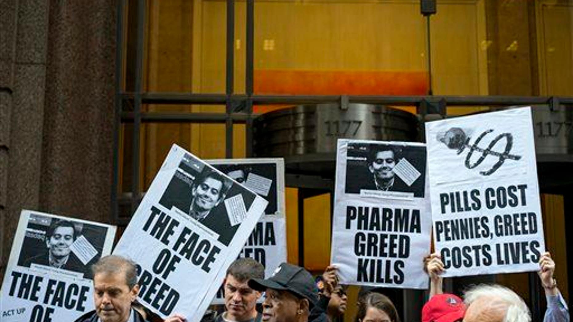 Activists hold signs containing the image of Turing Pharmaceuticals CEO Martin Shkreli in front of Turing's offices in New York on Oct. 1, 2015, during a protest.