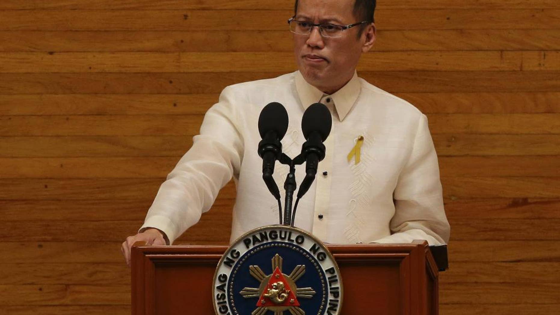Philippine President Benigno Aquino III pauses as he delivers his 5th State of the Nation Address during the joint session of the 16th Congress at the House of Representatives in suburban Quezon city, north of Manila, Philippines on Monday July 28, 2014. (AP Photo/Aaron Favila)