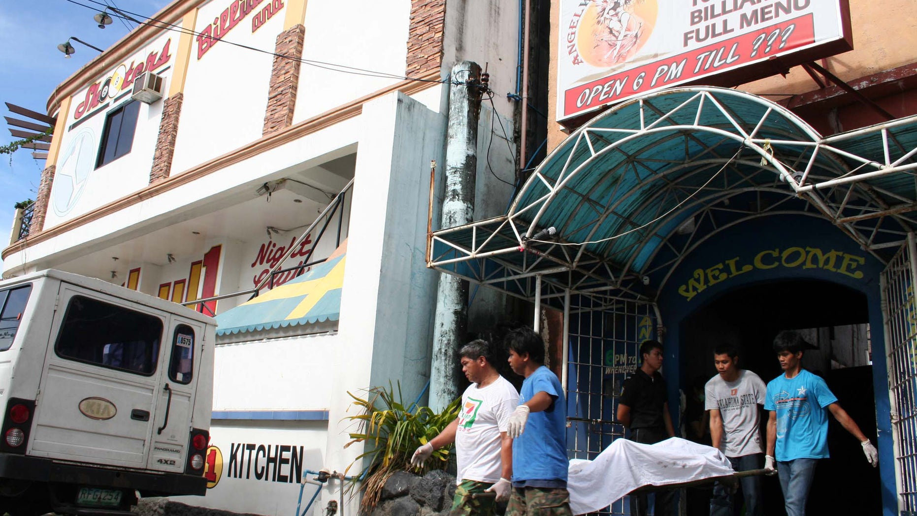 Jan. 11, 2013 - Funeral workers carry the body of a victim following a fire at a small 2-story hotel at Olongapo city, a former U.S. naval base, west of Manila, Philippines.