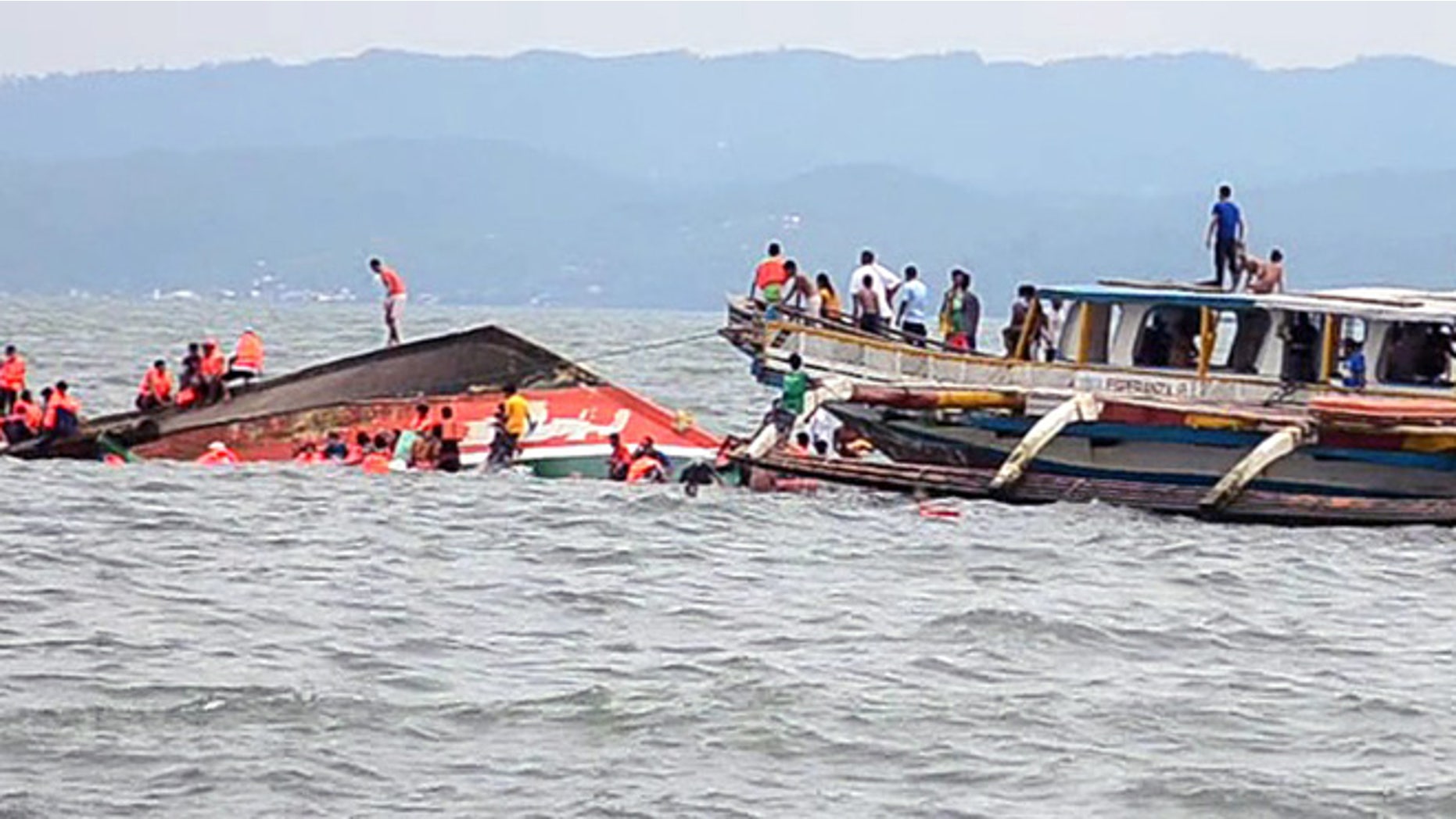 July 2, 2015: The Philippine Coast Guard rescues boat passengers after a ferry boat capsized in choppy waters in Ornoc, Philippines.