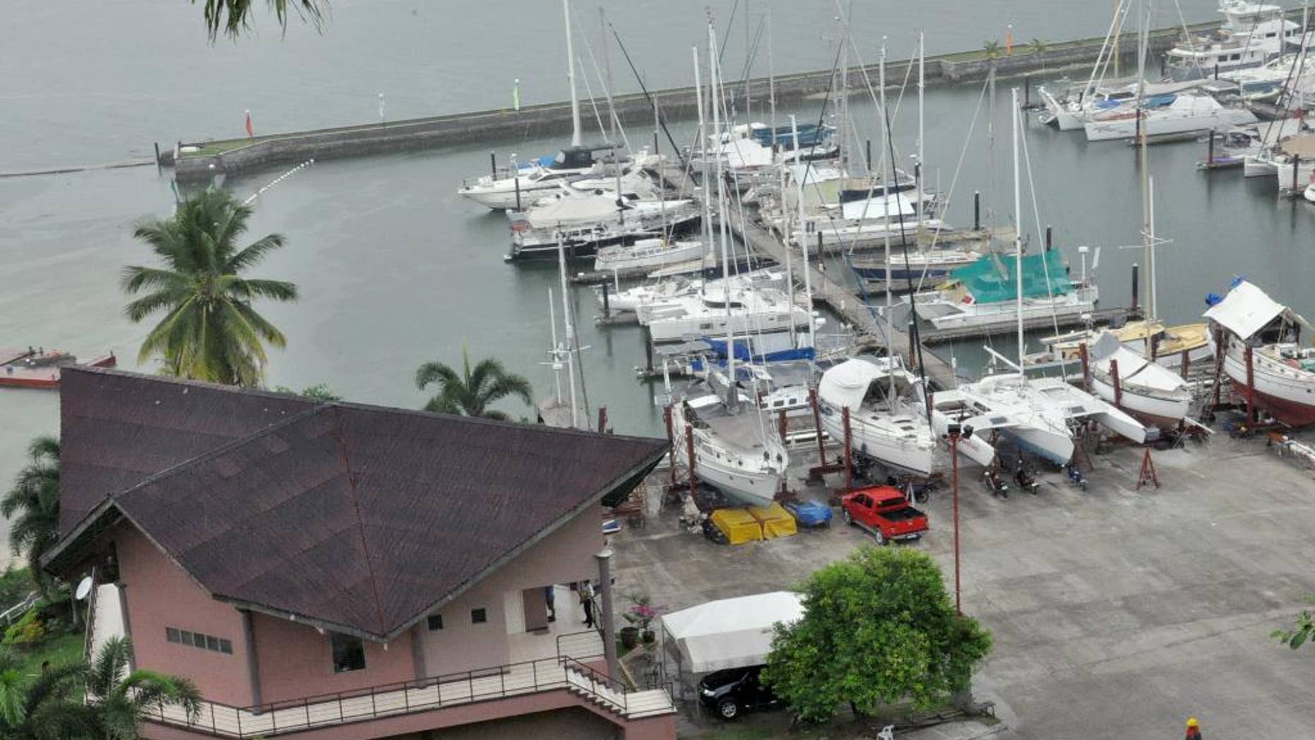 A man walks inside the compound of Holiday Ocean View Samal Resort, on Samal Island in southern Philippines Tuesday, Sept. 22, 2015, a day after unidentified gunmen abducted a Norwegian resort manager, two Canadians and a Filipino woman from this southern Philippine island, the military and police said. The gunmen appeared to have specifically targeted the victims when they entered the Holiday Ocean View Samal Resort before midnight Monday on the northern tip of Samal Island off Davao City, about 975 kilometers (610 miles) southeast of Manila, Philippines, regional military spokesman Capt. Alberto Caber said. (AP Photo/Manuel Cayon)