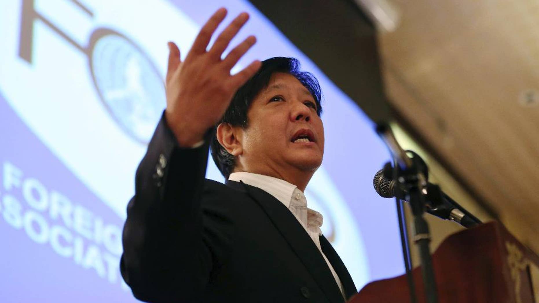 FILE - In this Feb. 11, 2015 file photo, Sen. Ferdinand "Bongbong" Marcos Jr. gestures during his speech as he talks about the Bangsamoro Basic Law during the Foreign Correspondents Association of the Philippines meeting in Manila, Philippines. The son of late Philippine dictator Ferdinand Marcos has announced that he will run for vice president in next year's elections in a new gauge of his family's political clout nearly three decades after they were ousted in a "people power" revolt. Marcos asked Filipinos in a statement Monday, Oct. 5, 2015 to judge him based on his 26-year career in government as a provincial official and national lawmaker. (AP Photo/Aaron Favila, File)