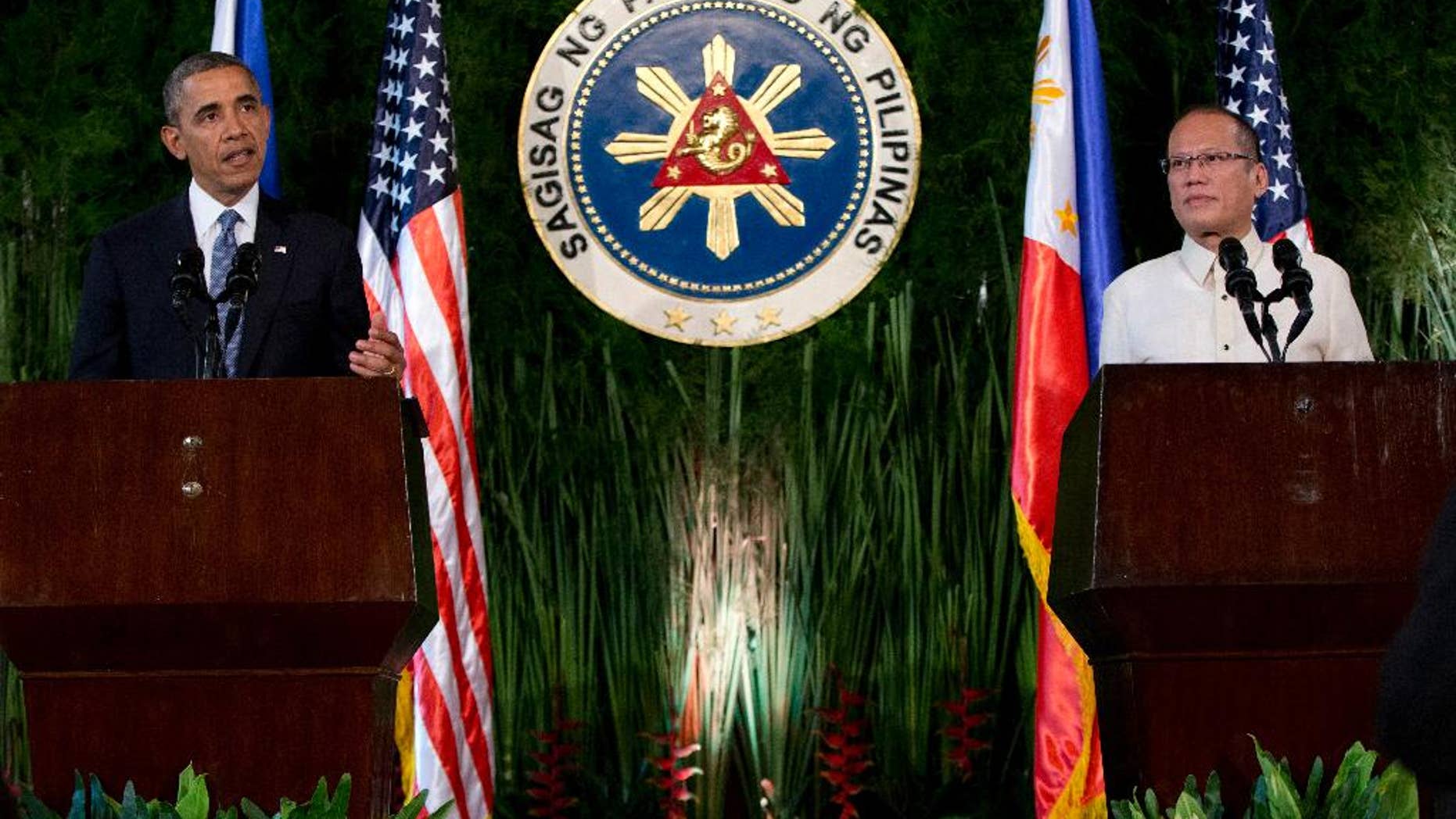 U.S. President Barack Obama, left, speaks as Philippine President Benigno Aquino III looks on during a joint news conference at Malacanang Palace in Manila, the Philippines, Monday, April 28, 2014. Obama is assuring Filipinos that a new security agreement doesn't mean the U.S. is trying to reestablish military bases in their country. Obama says a deal signed Monday to give the U.S. military greater access to Philippine bases will help strengthen security in the region. He said it also will allow for a faster response to natural disasters. (AP Photo/Carolyn Kaster)