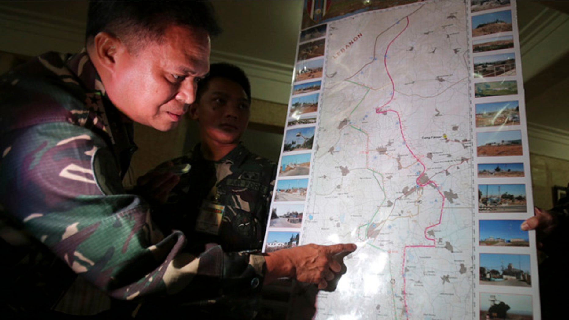 August 31, 2014: Philippine military chief Gen. Gregorio Pio Catapang shows reporters where Filipino peacekeepers in Golan Heights have been repositioned during a press conference at Camp Aguinaldo military headquarters in suburban Quezon city, Philippines. Catapang said more than 70 Filipino peacekeepers have escaped from two areas in the Golan Heights that came under attack by Syrian rebels. (AP Photo/Aaron Favila)