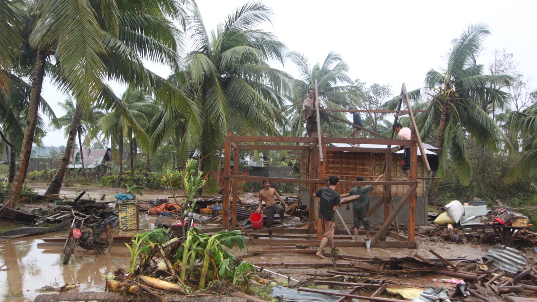 Dec. 4, 2012: Residents repair their damaged homes after Typhoon Bopha made landfall in Compostela Valley in southeastern Philippines.