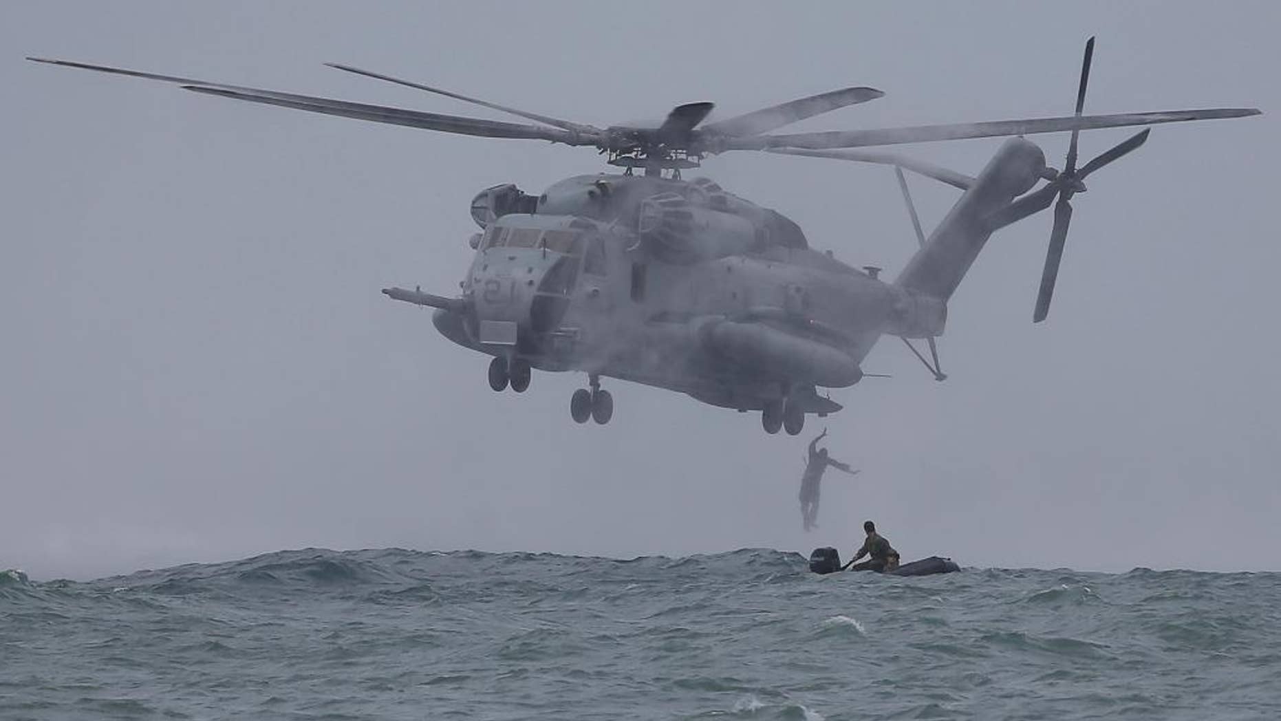 FILE - In this Sept. 20, 2013 file photo, Filipino Marines and U.S. Marines from the 13th Marine Expeditionary Unit BOXER Amphibious Ready Group based in Okinawa, Japan drop from a CH-53 Super Stallion helicopter during a joint military exercise called Philippines-U.S. Amphibious Landing Exercise (PHIBLEX) in Ternate, Cavite province, southern Philippines. A new defense pact that will allow thousands of U.S. troops to be temporarily based in Philippines for the first time in more than 20 years signals closer cooperation in the allies’ hot-and-cold relationship that has been shaped over the decades by war, terrorism and now, jitters over China's rise. The 10-year agreement, signed Monday, April 28, 2014, as President Barack Obama arrived in Manila, was considered the centerpiece of his four-nation Asian trip, which he used to reassure allies like Japan and the Philippines of American military backing as they wrangle with China in increasingly tense territorial disputes. (AP Photo/Aaron Favila, File)