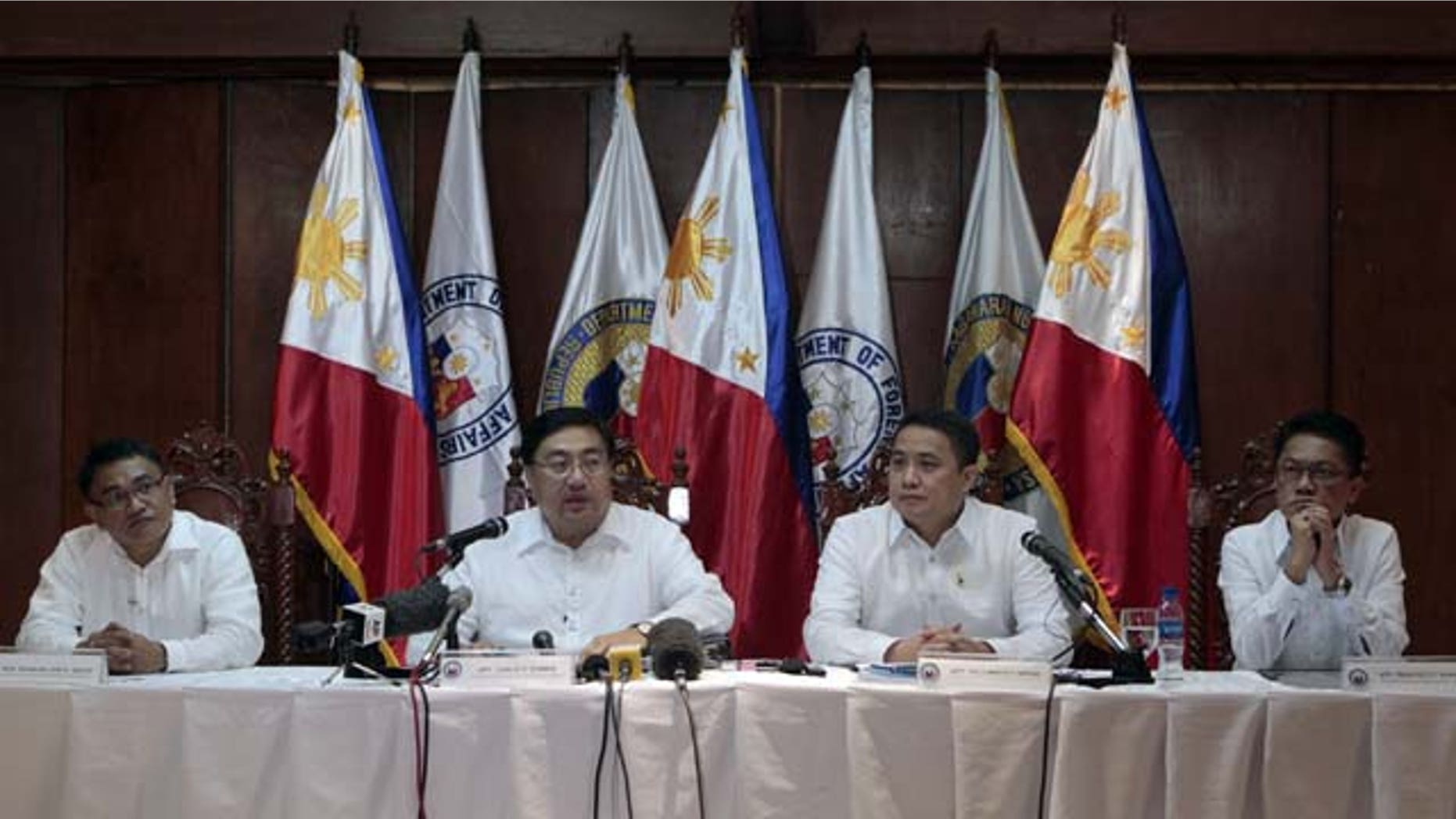 August 12, 2013: Philippine chief government negotiator Carlos Sorreta, second from left, answers questions from reporters beside fellow negotiators, at Camp Aguinaldo military headquarters in suburban Quezon City, north of Manila.