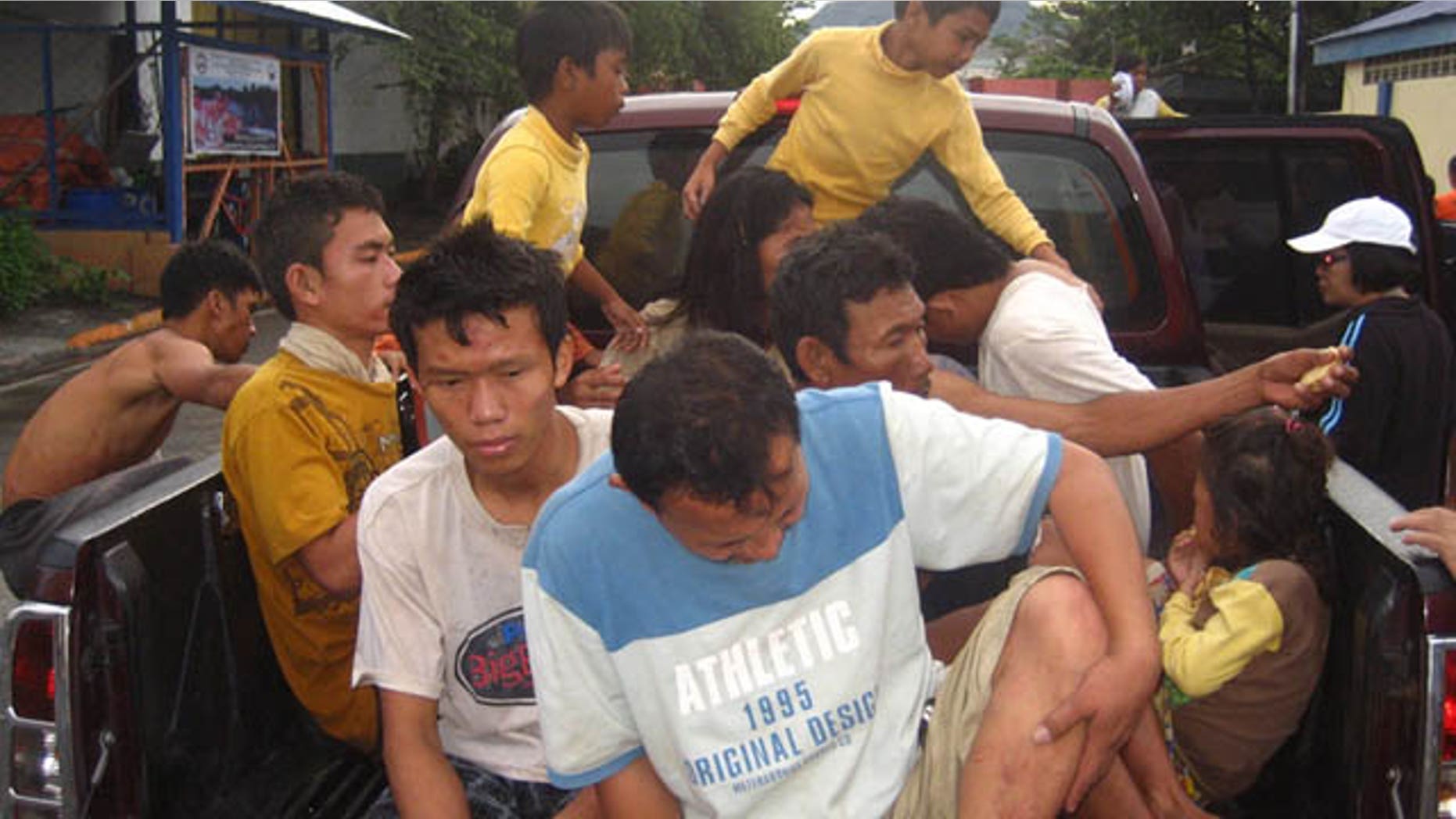 December 18, 2011: Rescued residents board a vehicle at Iligan city, southern Philippines.
