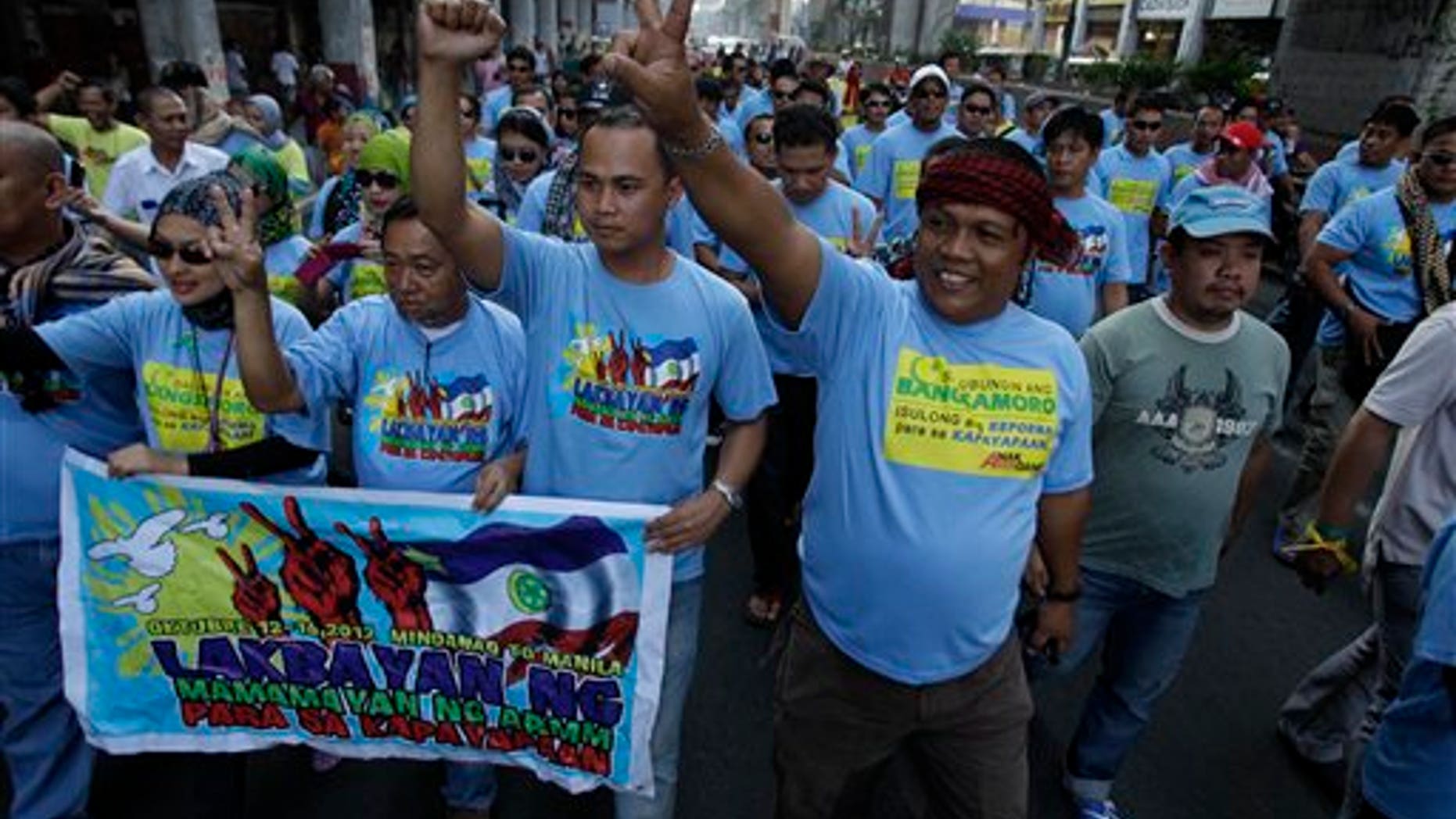 Oct. 14, 2012: Filipino Muslim men and supporters march as they join a rally in support of a preliminary peace agreement between the government and the nation's largest Muslim rebel group outside the Malacanang presidential palace in Manila, Philippines.