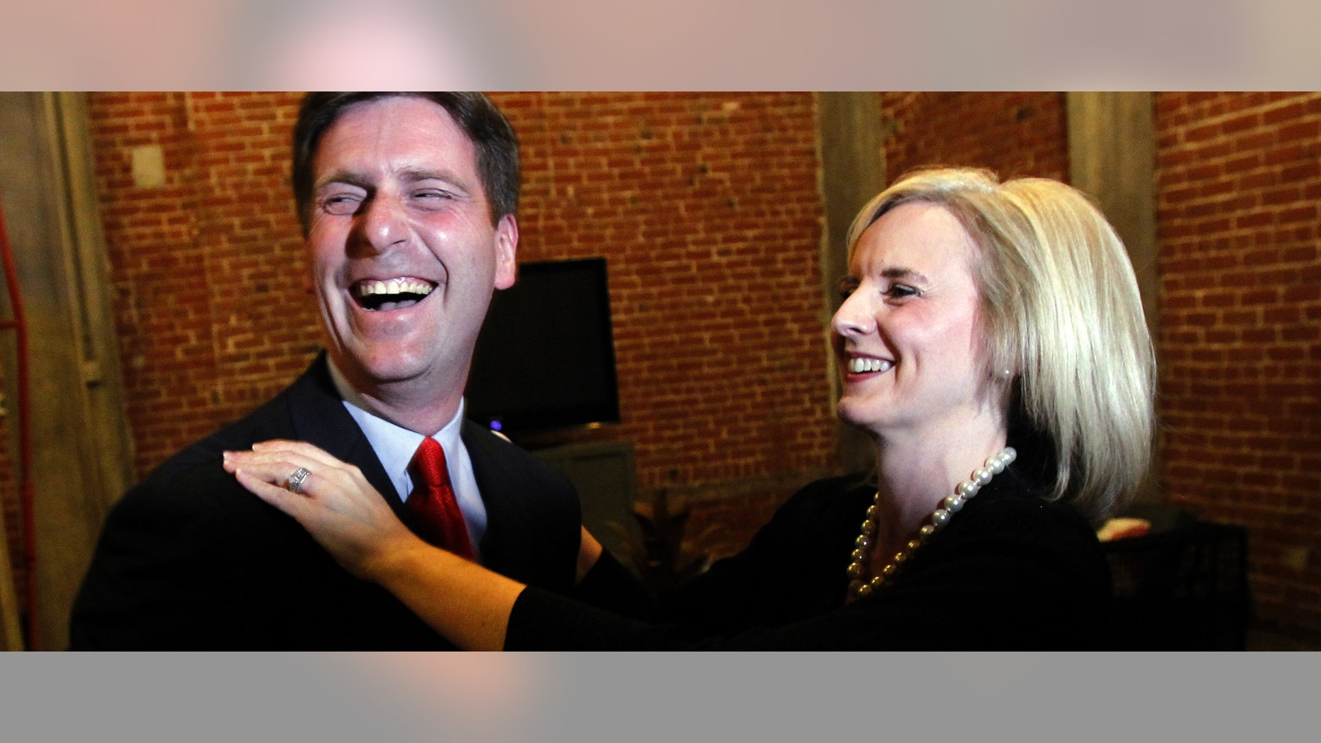 Democratic candidate for Phoenix mayor Greg Stanton, left, celebrates with his wife Nicole France Stanton after learning about positive early election results, Tuesday, Nov. 8, 2011, in Phoenix. Stanton defeated Republican Wes Gullett to become the new mayor of Phoenix. (AP Photo/Ross D. Franklin)