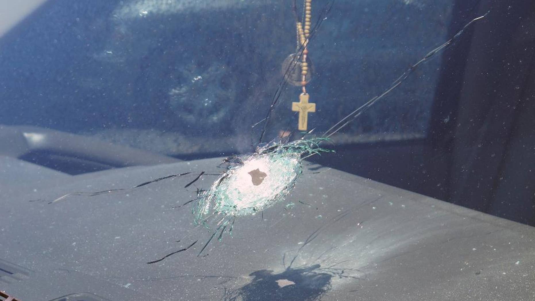 This undated photo released by the Arizona Department of Public Safety shows a bullet hole in the windshield of a vehicle in Phoenix. Four vehicles traveling on the same freeway in the heart of Phoenix have been struck by gunshots in the last week, and the state police agency is appealing for information from the public as it conducts what it says is a robust investigation. (Arizona Department of Public Safety via AP)