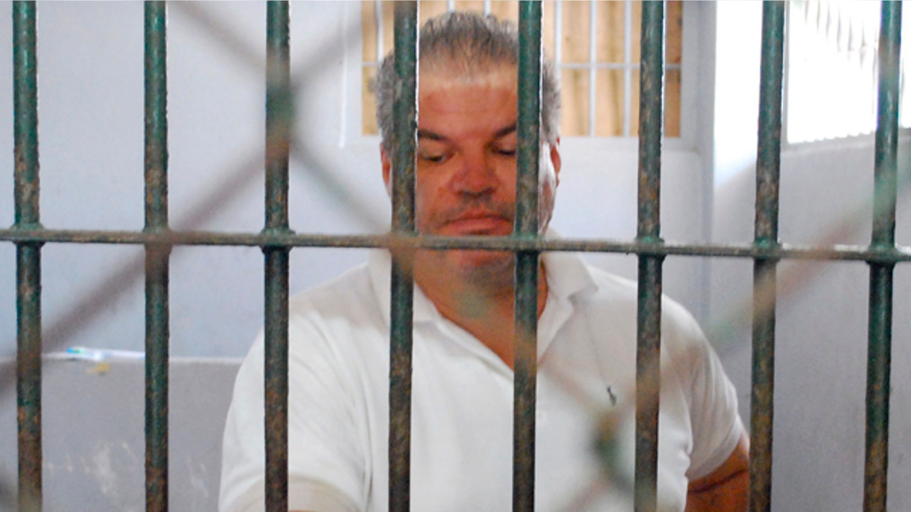 March 1: Norwegian Stein Havard Dokset stands behind bars at the Phuket police station after he was arrested in southern Thailand.