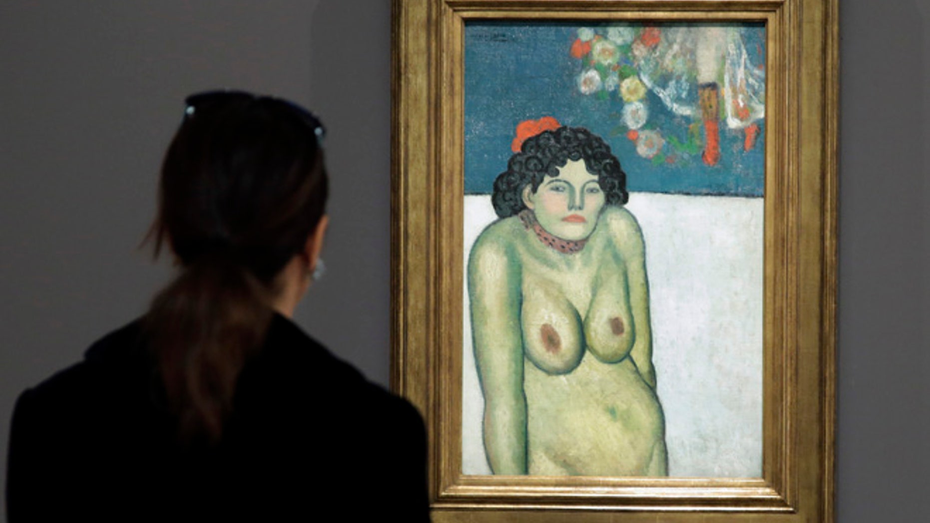 FILE - This Oct. 30, 2015 file photo shows "The Nightclub Singer,â a 1901 painting by Picasso from his Blue Period, at Sotheby's in New York. The work features a second picture on the reverse side depicting Picassoâs art dealer, Pere Manach. The piece is estimated to fetch $60 million on Thursday night, Nov. 5, 2015 at Sothebyâs fall art auction. (AP Photo/Richard Drew, File)