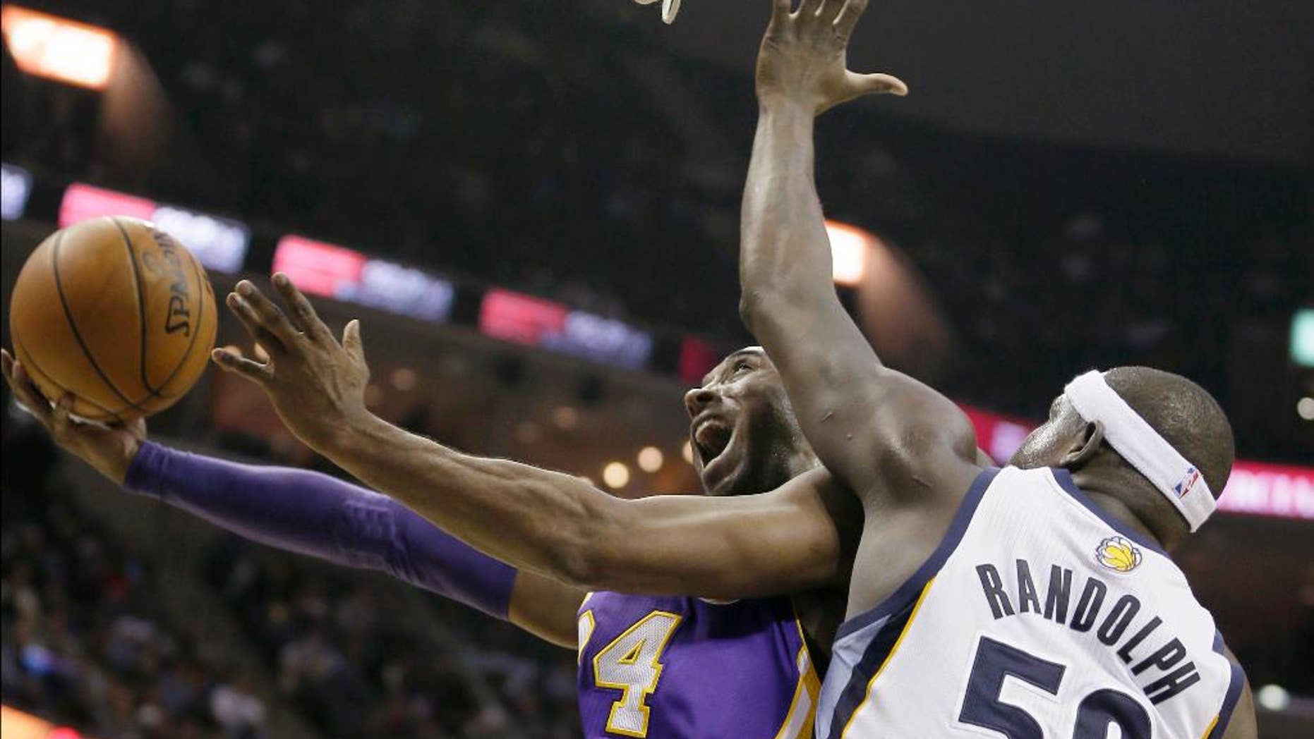 FILE - In this Dec. 17, 2013, file photo, Los Angeles Lakers' Kobe Bryant goes to the basket in front of Memphis Grizzlies' Zach Randolph (50) during the first half of an NBA basketball game in Memphis, Tenn. Bryant’s 19th season gets started Tuesday, Oct. 28, 2014, when the Lakers open at home against the Houston Rockets. What he has left in the tank after two injury-filled years might be one of the biggest questions heading into the season, with the Lakers already being widely written off in the loaded Western Conference and Bryant hardly expected to regain the elite form that he displayed for so long. (AP Photo/Danny Johnston, File)