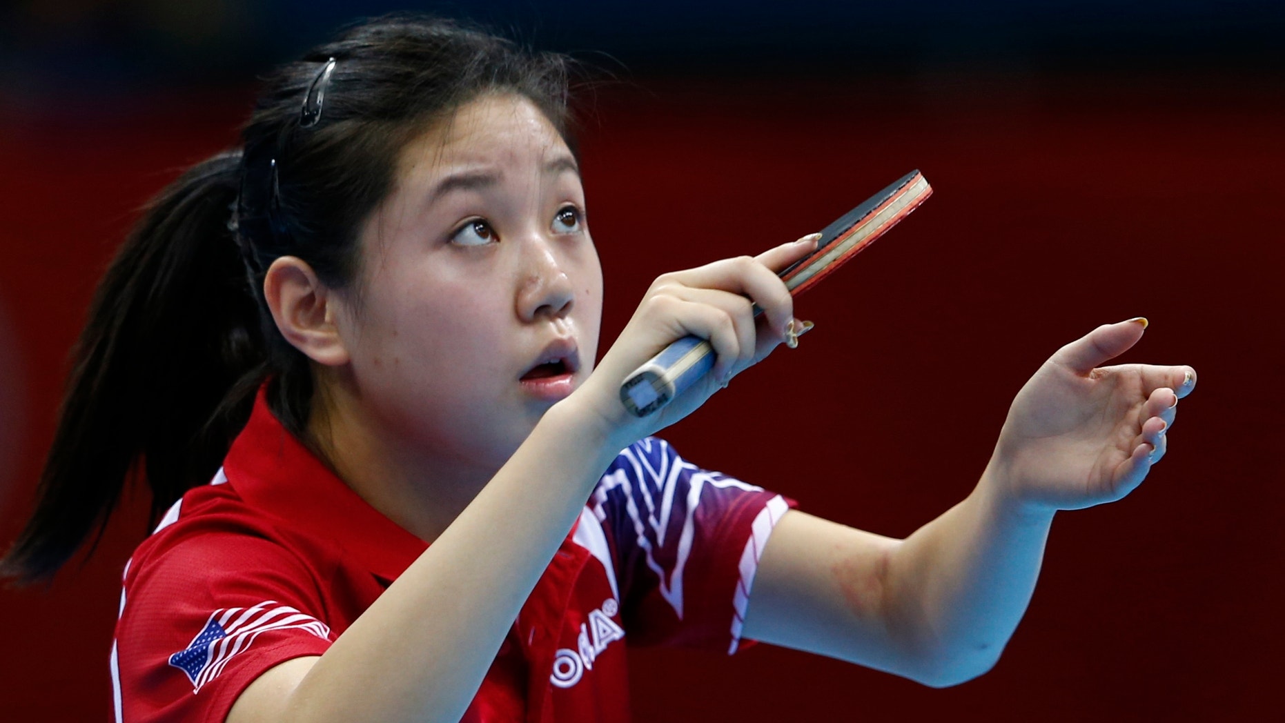 July 28, 2012: Lily Zhang of the U.S. serves to Croatia's Cornelia Molnar during their women's singles first round table tennis match in the ExCel venue at the London 2012 Olympic Games.