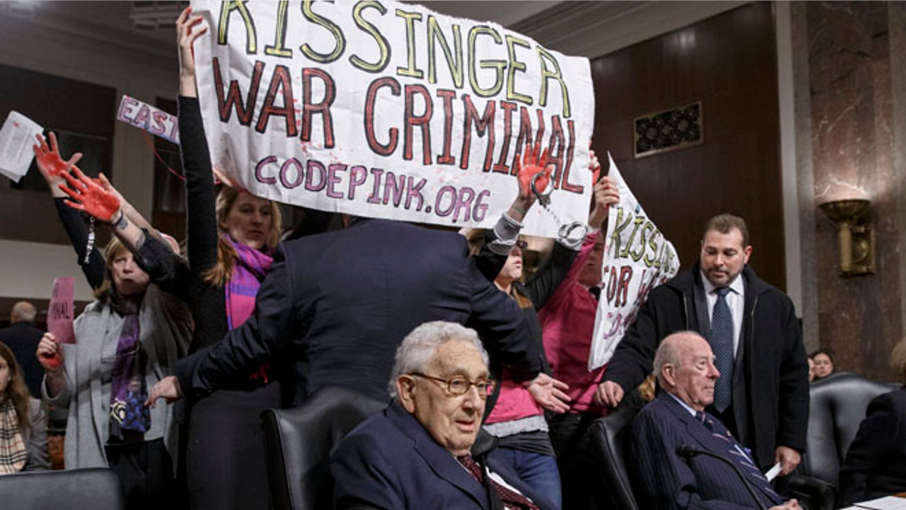 FILE: Jan. 29, 2015: Code Pink protesters at the Senate Armed Services hearing attended by former Secretary of State Henry A. Kissinger, Capitol Hill, Washington, D.C.