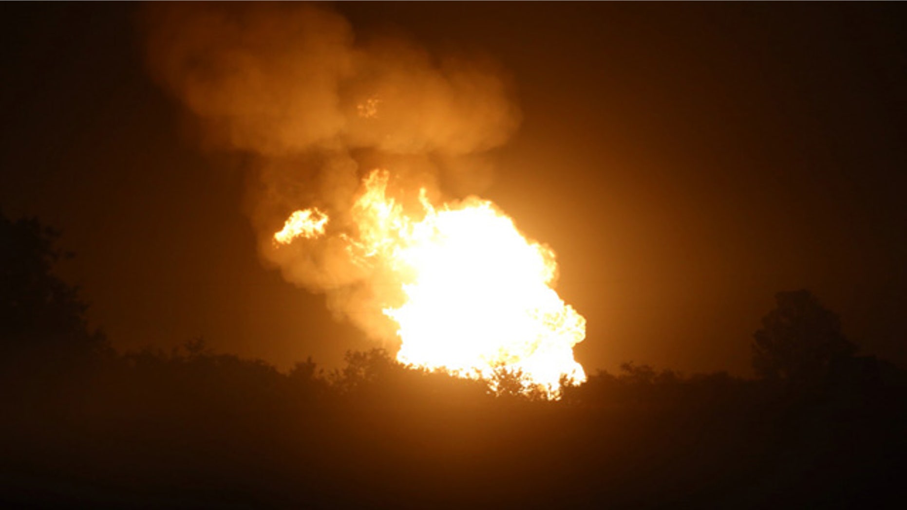 June 14, 2015: Fire after a pipeline explosion in rural DeWitt County, Texas, illuminates the horizon. Authorities said no one was injured after a natural gas pipeline rupture sparked a massive fire that prompted home evacuations in South Texas. (Richard Hoang/The Victoria Advocate via AP)