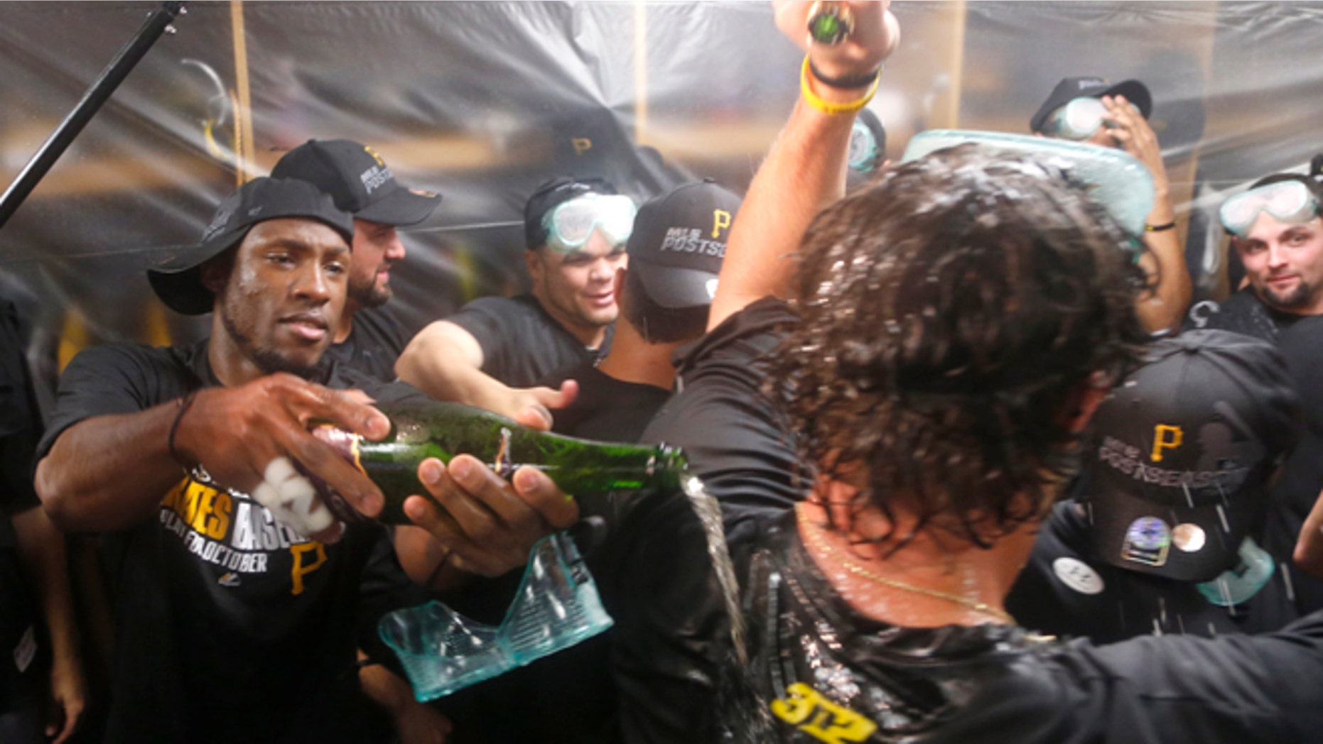 Pittsburgh Pirates left fielder Starling Marte, left, celebrates with teammates after the Pirates clinched a post season berth with a 2-1 win over the Chicago Cubs Monday, Sept. 23, 2013, in Chicago. (AP Photo/Charles Rex Arbogast)