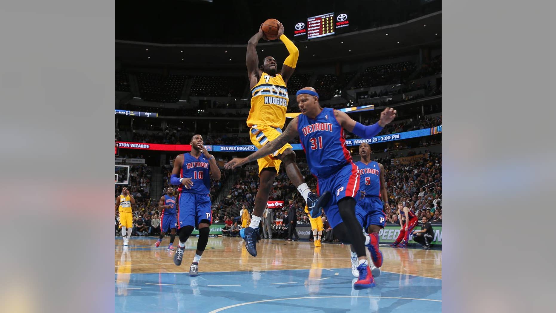 Denver Nuggets forward J.J. Hickson, center, drives for basket as Detroit Pistons forward Charlie Villanueva, right, and center Greg Monroe cover in the fourth quarter of the Nuggets' 118-109 victory in an NBA basketball game in Denver on Wednesday, March 19, 2014. (AP Photo/David Zalubowski)