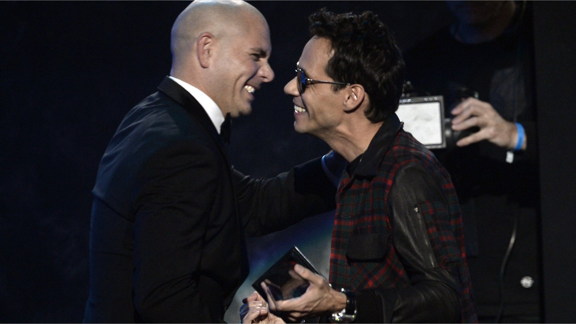 LOS ANGELES, CA - NOVEMBER 24: Host Pitbull (L) and musician Marc Anthony onstage during the 2013 American Music Awards at Nokia Theatre L.A. Live on November 24, 2013 in Los Angeles, California. (Photo by Kevin Winter/Getty Images)