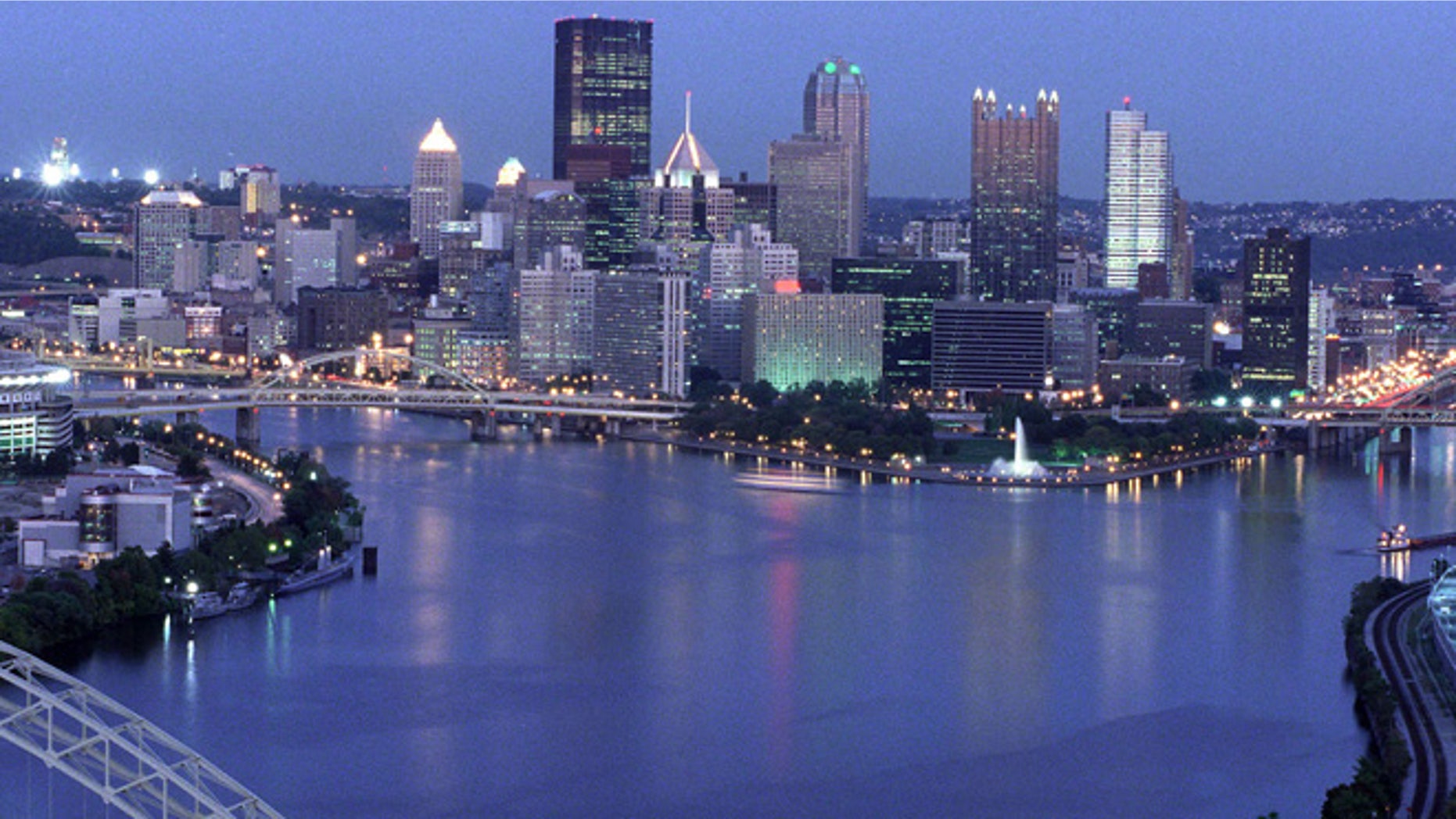 View of the downtown Pittsburgh skyline at dusk, showing the Allegheny and Monongahela rivers joining to form the Ohio River. Three Rivers Stadium is on the left. October 7, 1999. (Photo by Steven Adams/Getty Images)
