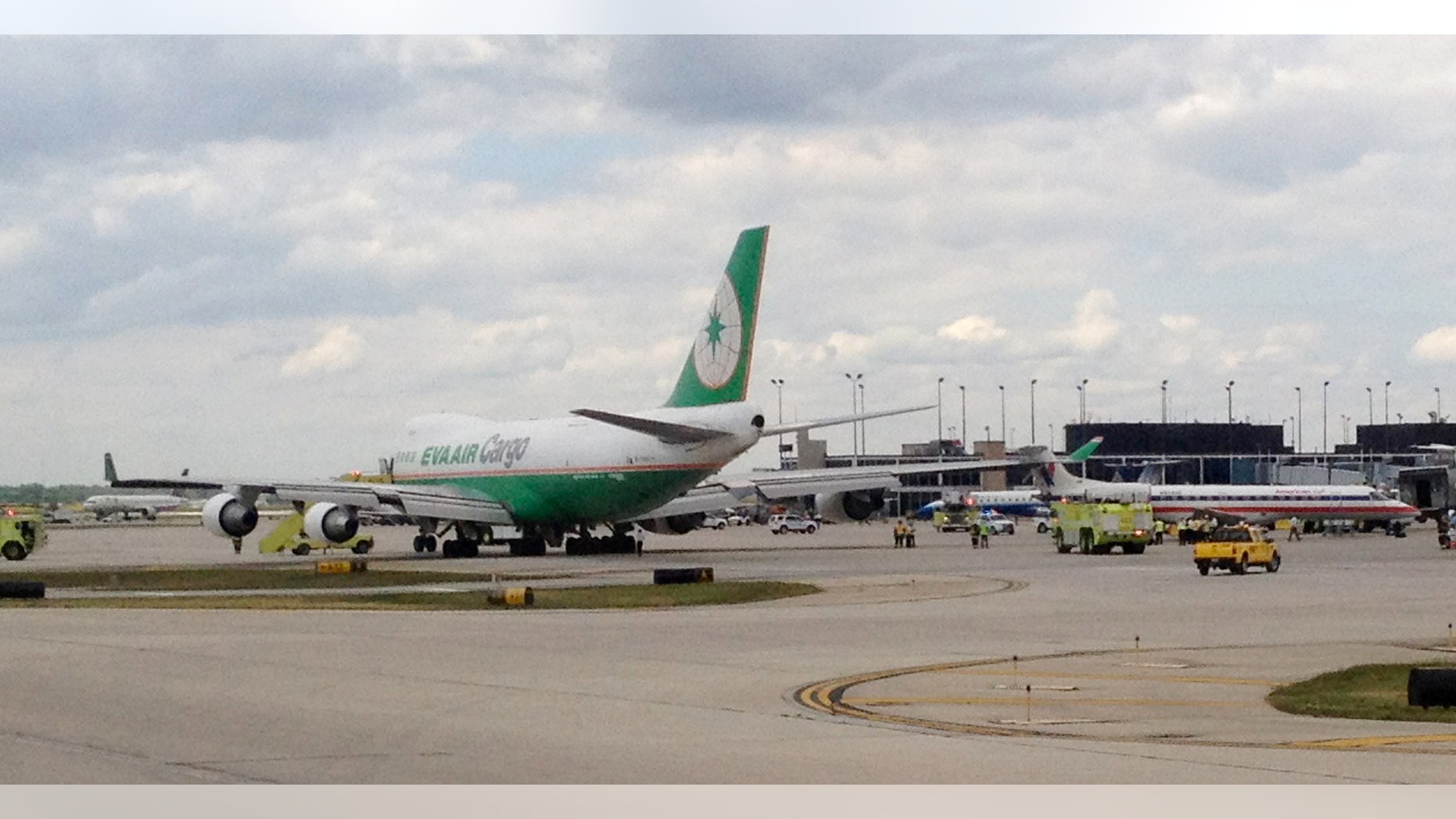 May 30, 2012: Emergency crews surround an An Eva Air Cargo plane, left, after it clipped the rudder of an American Eagle plane, right, at Chicago O'Hare International Airport in Chicago.