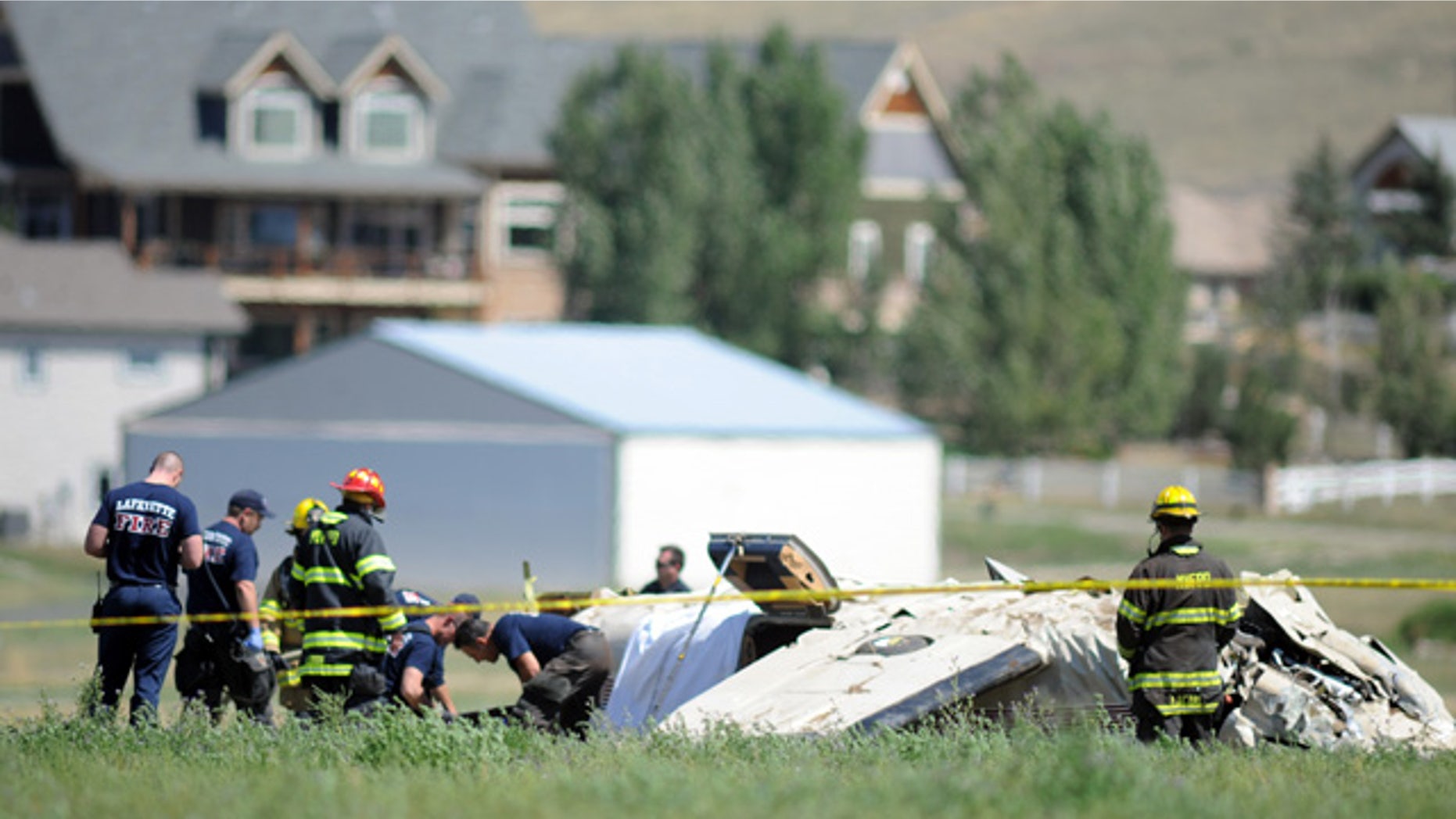 August 31, 2014: Police and firefighters work on the scene where three people were killed and two others injured after an airplane crashed in a field northwest of the main runway at Erie Municipal Airport while coming in for a landing in Erie, Colo. (AP Photo/The Daily Camera, Cliff Grassmick)