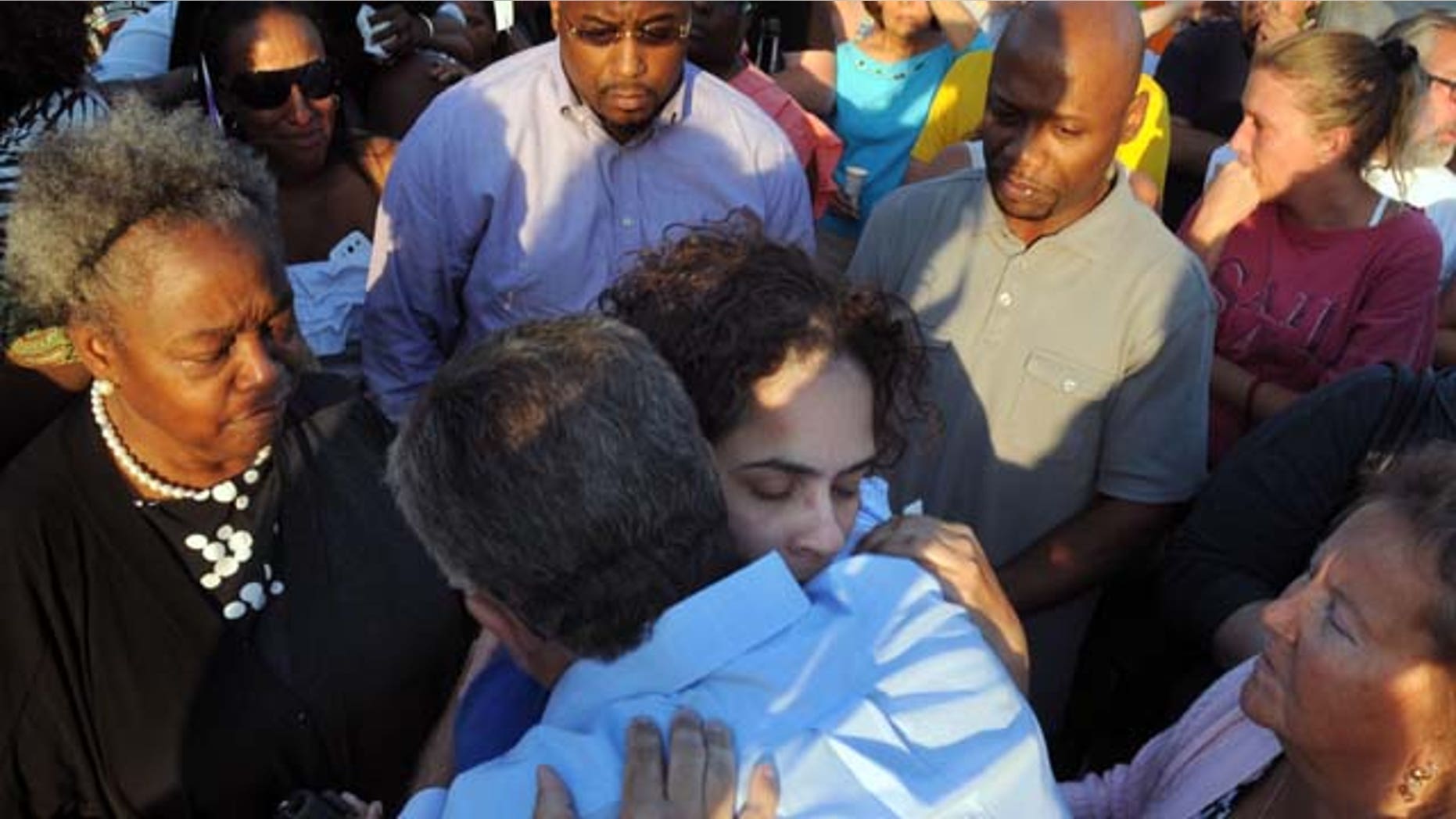 August 10, 2013: Joann Mitchell, the mother of one of the crash victims, hugs East Haven Mayor Joseph Maturo, during a vigil in East Haven, Conn. (AP Photo)