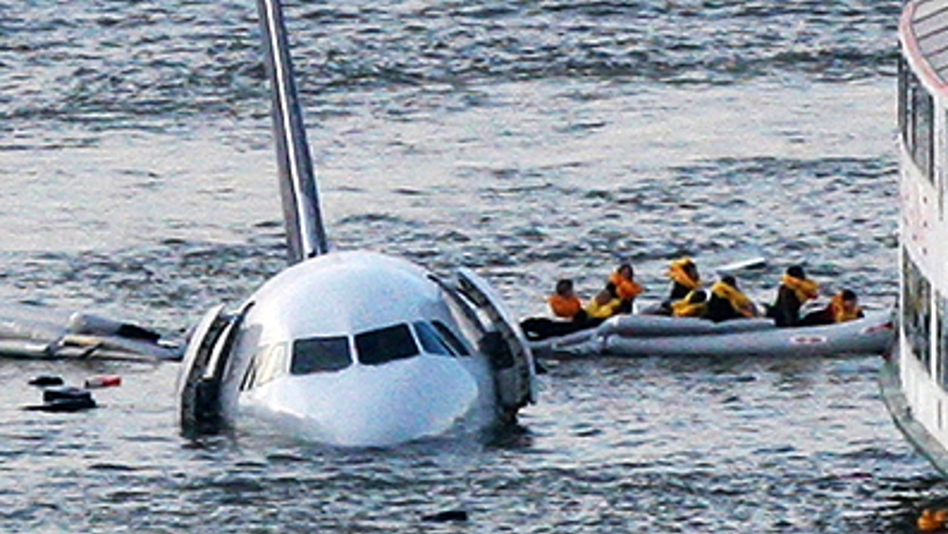 In this Jan. 15, 2009 file photo, passengers in an inflatable raft move away from an Airbus 320 US Airways aircraft that has gone down in the Hudson River in New York. The Charlotte Observer reported Wednesday, Jan. 5, 2011 that the Carolinas Aviation Museum in Charlotte, N.C. has almost completed an agreement to buy the US Airways jet that made a near-miraculous landing on the Hudson River in 2009 from the insurance company that owns it. (AP Photo/Bebeto Matthews, FILE)