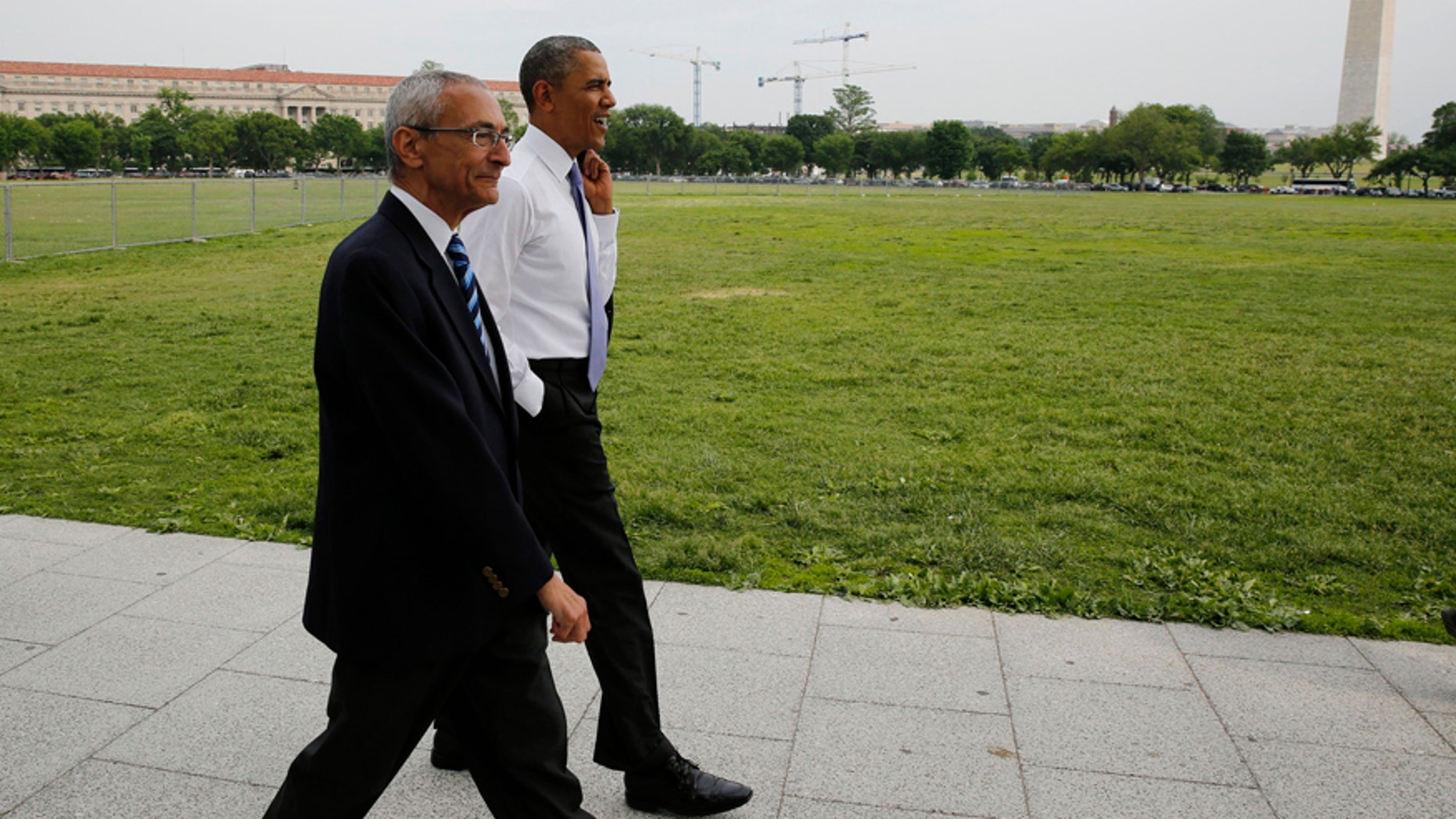 U.S. President Barack Obama walks on the Ellipse with White House counselor John Podesta near the White House in Washington May 21, 2014.