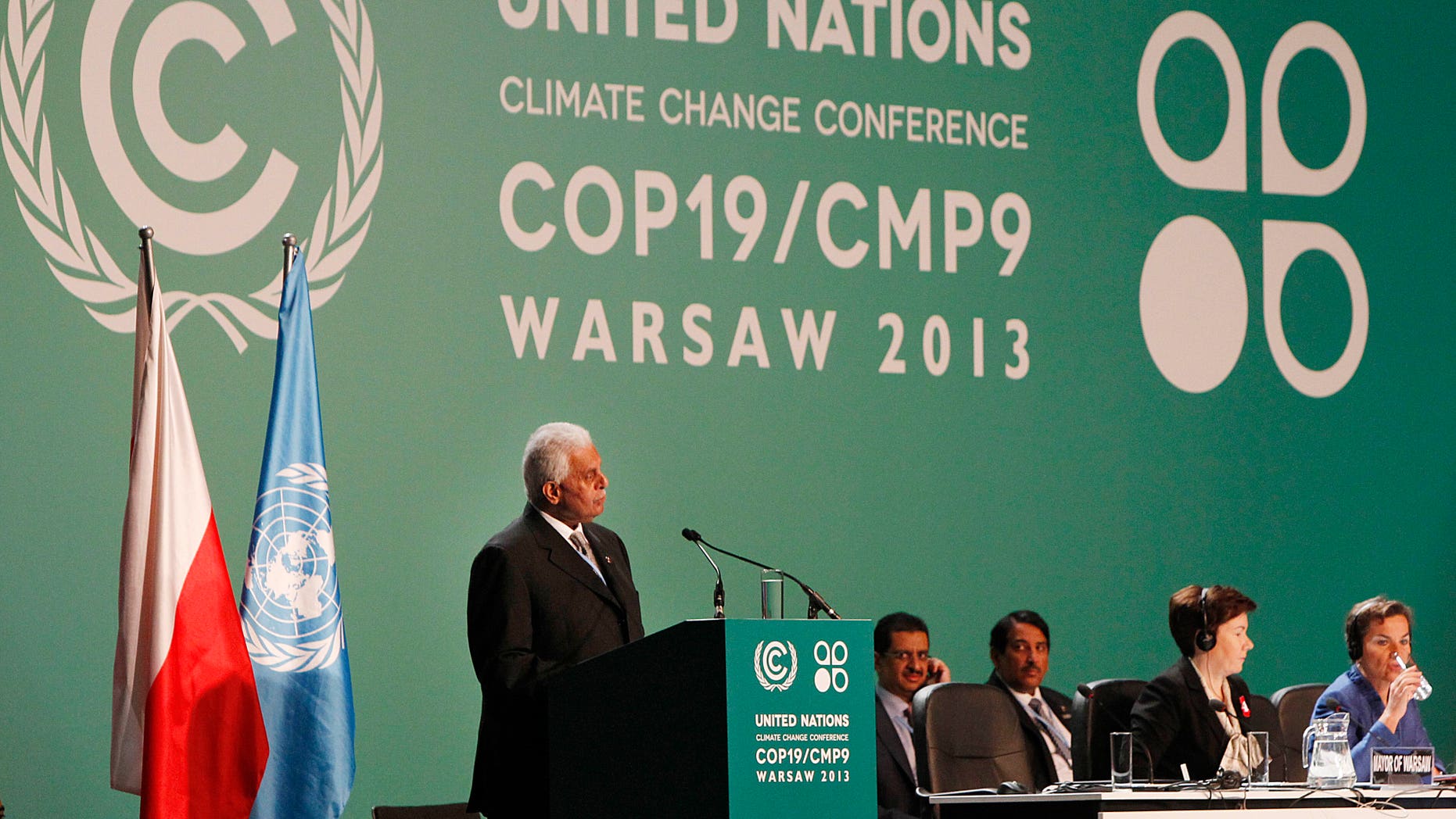 Qatar's Abdullah Bin Hamad Al-Attiyah,left, President of previous COP18 ( Conference of Parties) addresses delegates during the opening session of the United Nations Climate Change Conference COP19 in Warsaw, Poland, Monday, Nov. 11, 2013. Thousands of participants from nations and environment organizations from around the world have opened two weeks of U.N. climate talks that are to lay the groundwork for a new pact to prevent global warming. (AP Photo/Czarek Sokolowski)